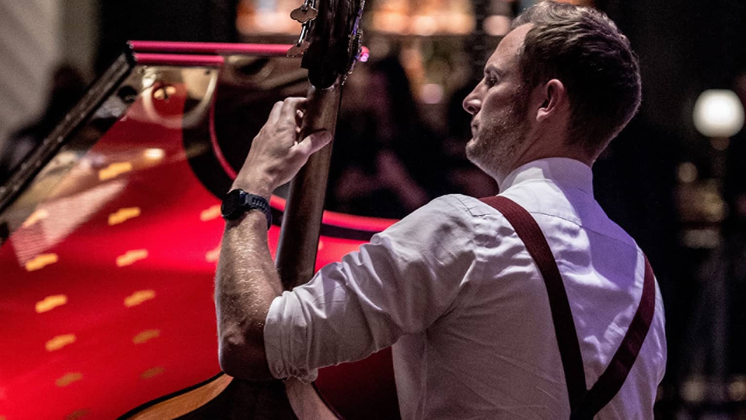 Bond Street Band, back of musician wearing suspenders and holding upright bass 
