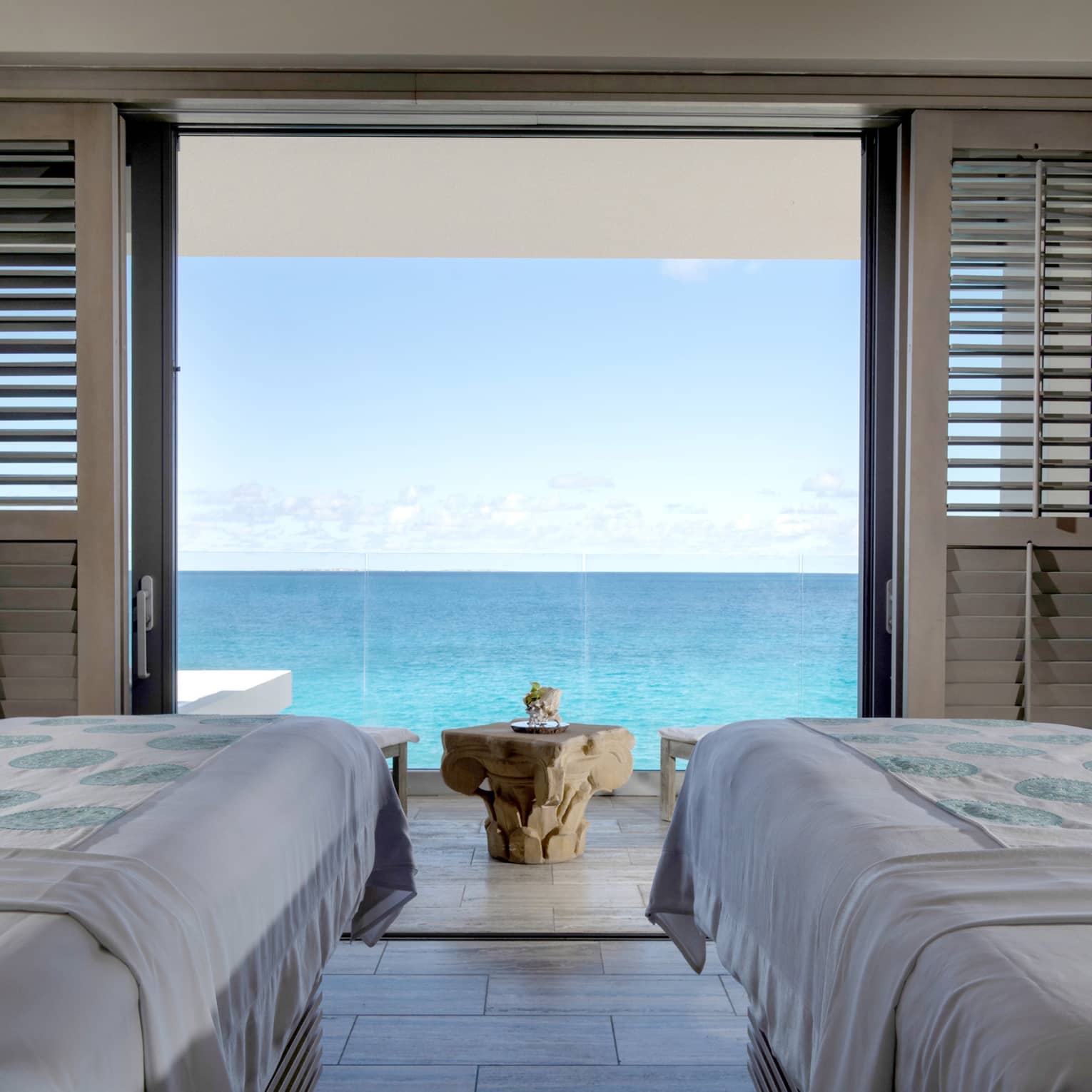 Couples massage beds in private spa cabana looking out at the ocean