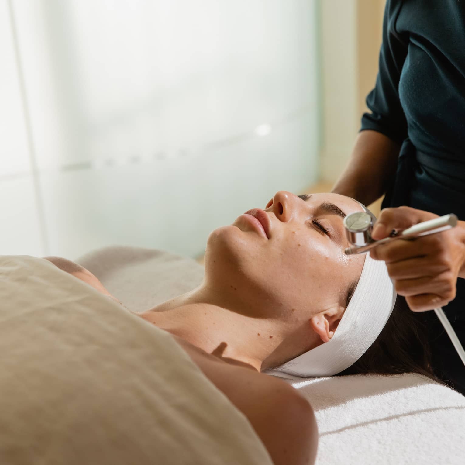 A woman gets a facial in luxury spa