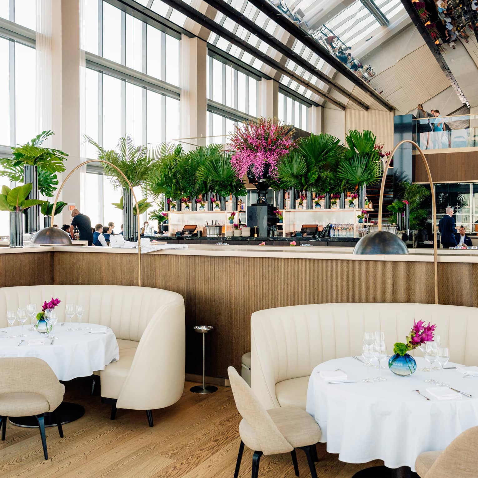 Dining tables in restaurant atrium with high ceilings