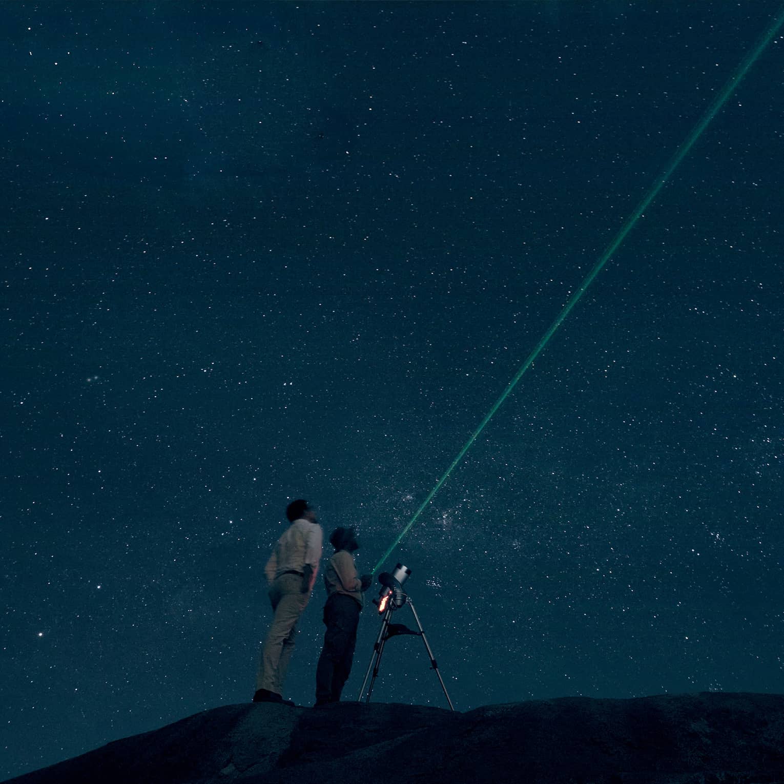 Two people stargazing at night