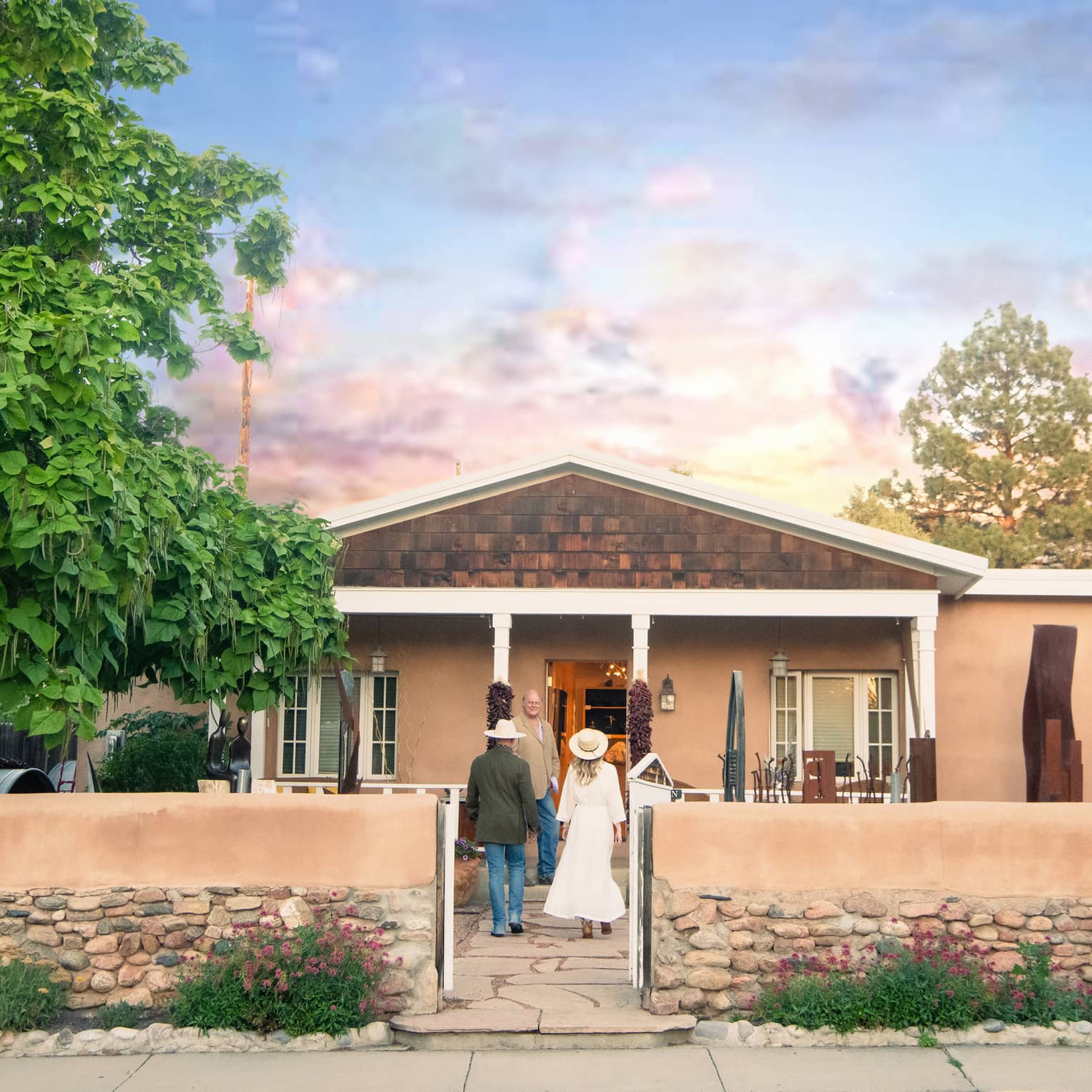 A man and woman walking up to a small building.