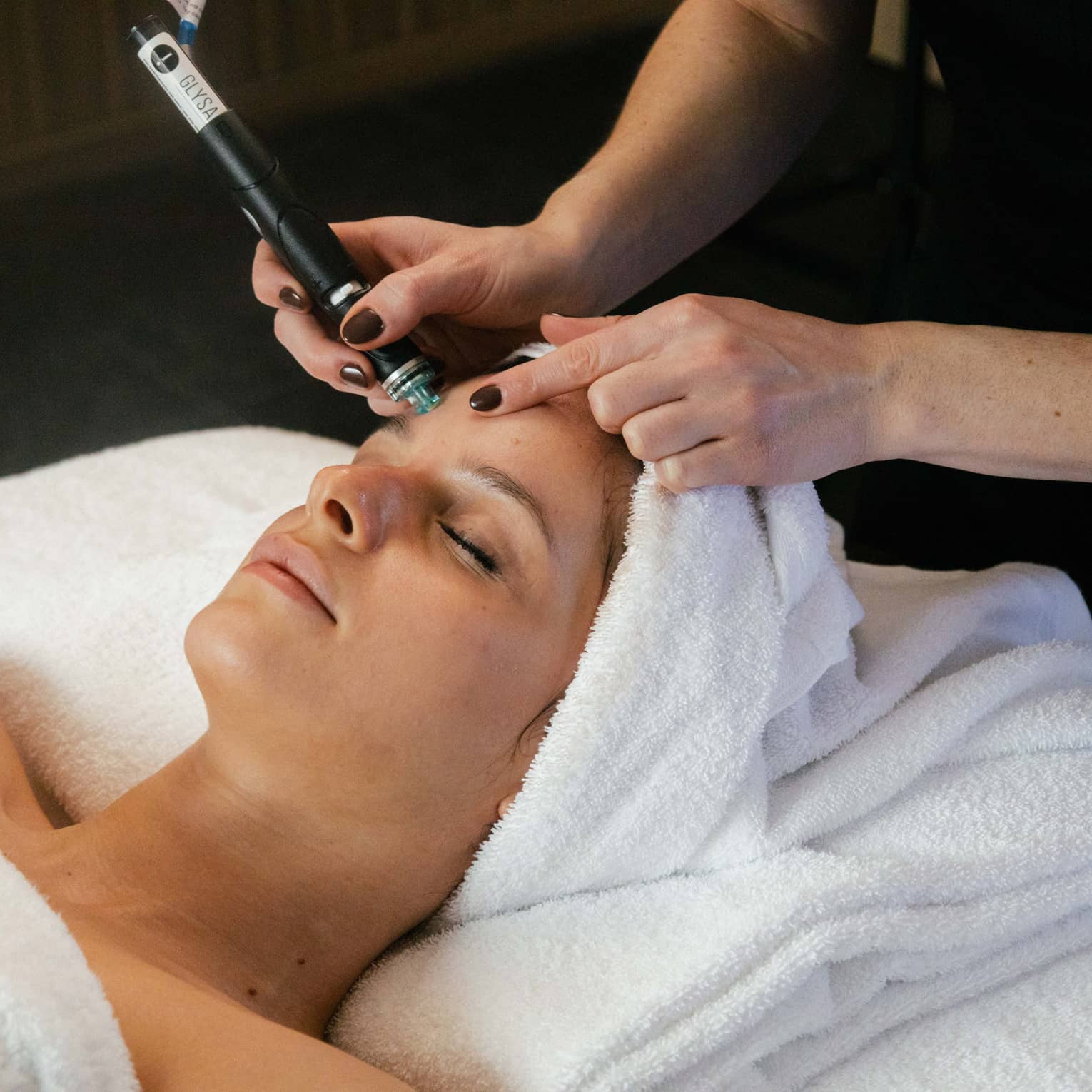 Woman on spa treatment table gets a Hydrafacial