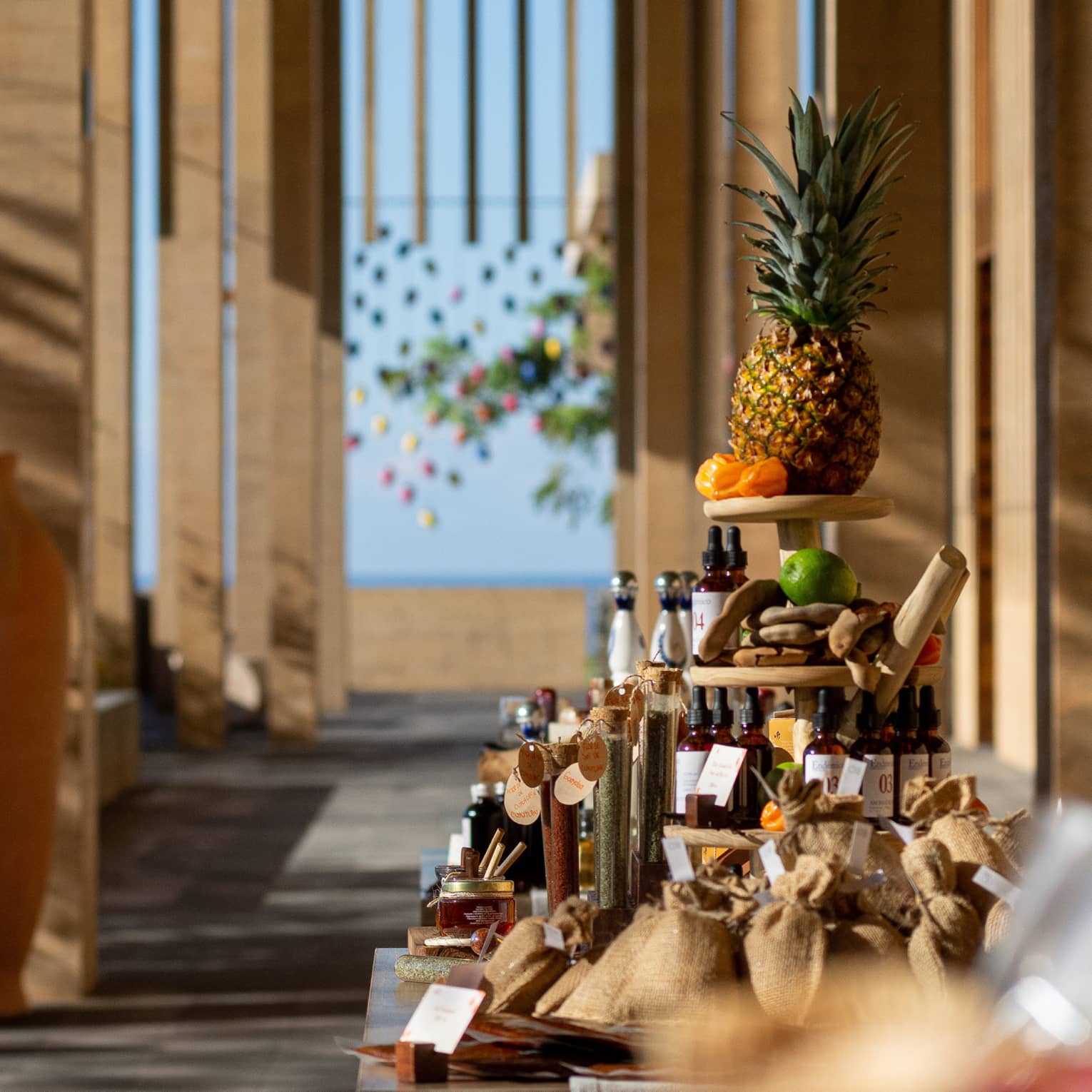 Display of various bottles and containers of items with a pineapple at the top of the display.