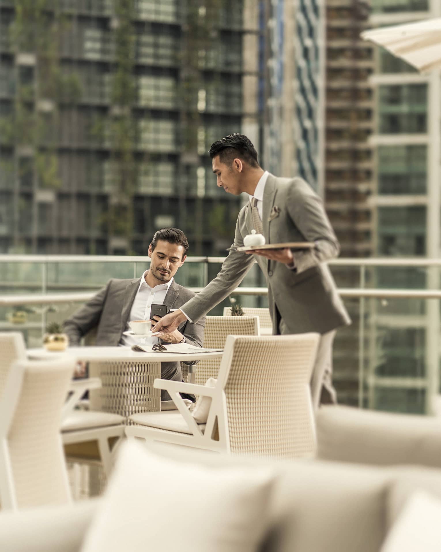 The outdoor terrace of Executive Club at Four Seasons Hotel Kuala Lumpur, with views of KLCC Park