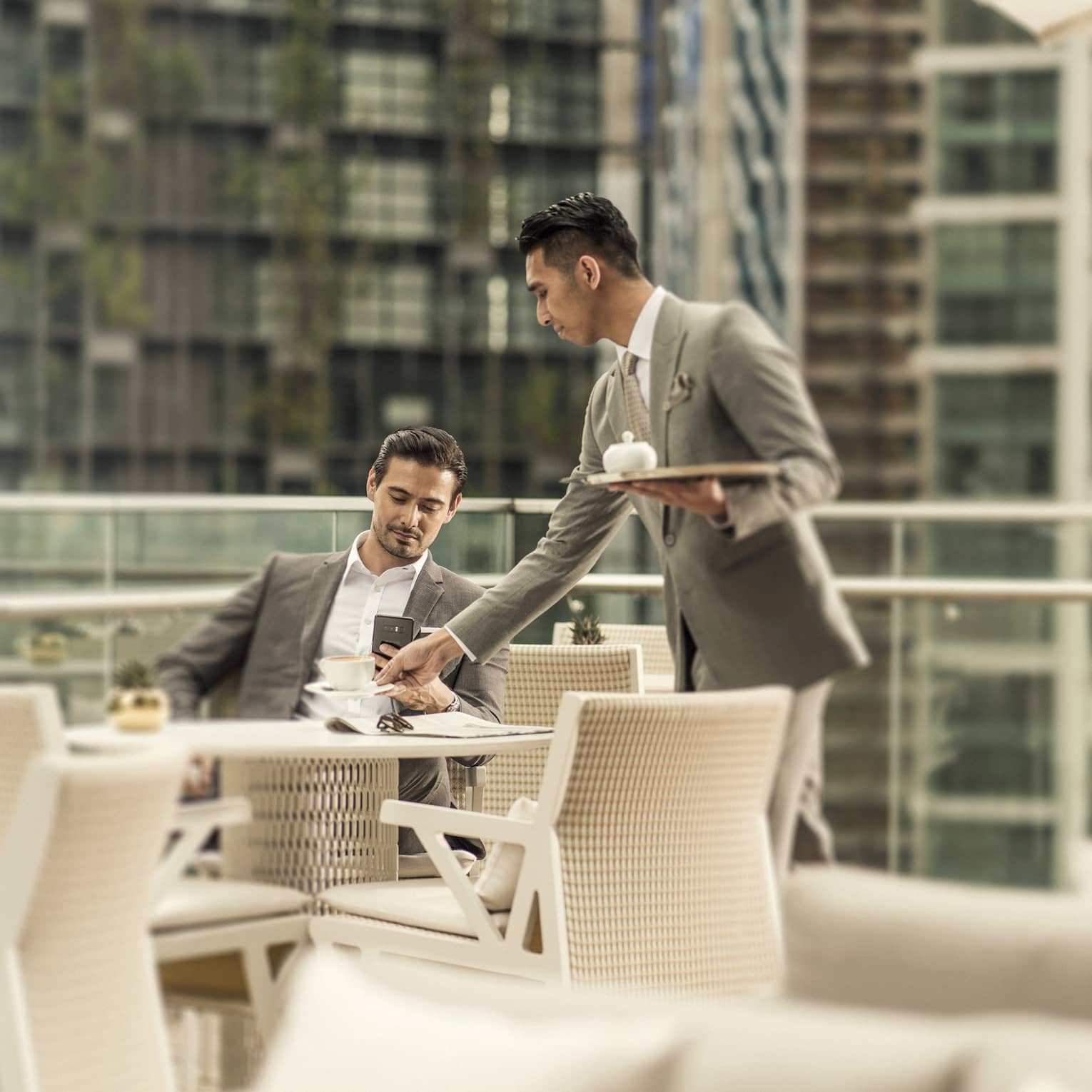 The outdoor terrace of Executive Club at Four Seasons Hotel Kuala Lumpur, with views of KLCC Park