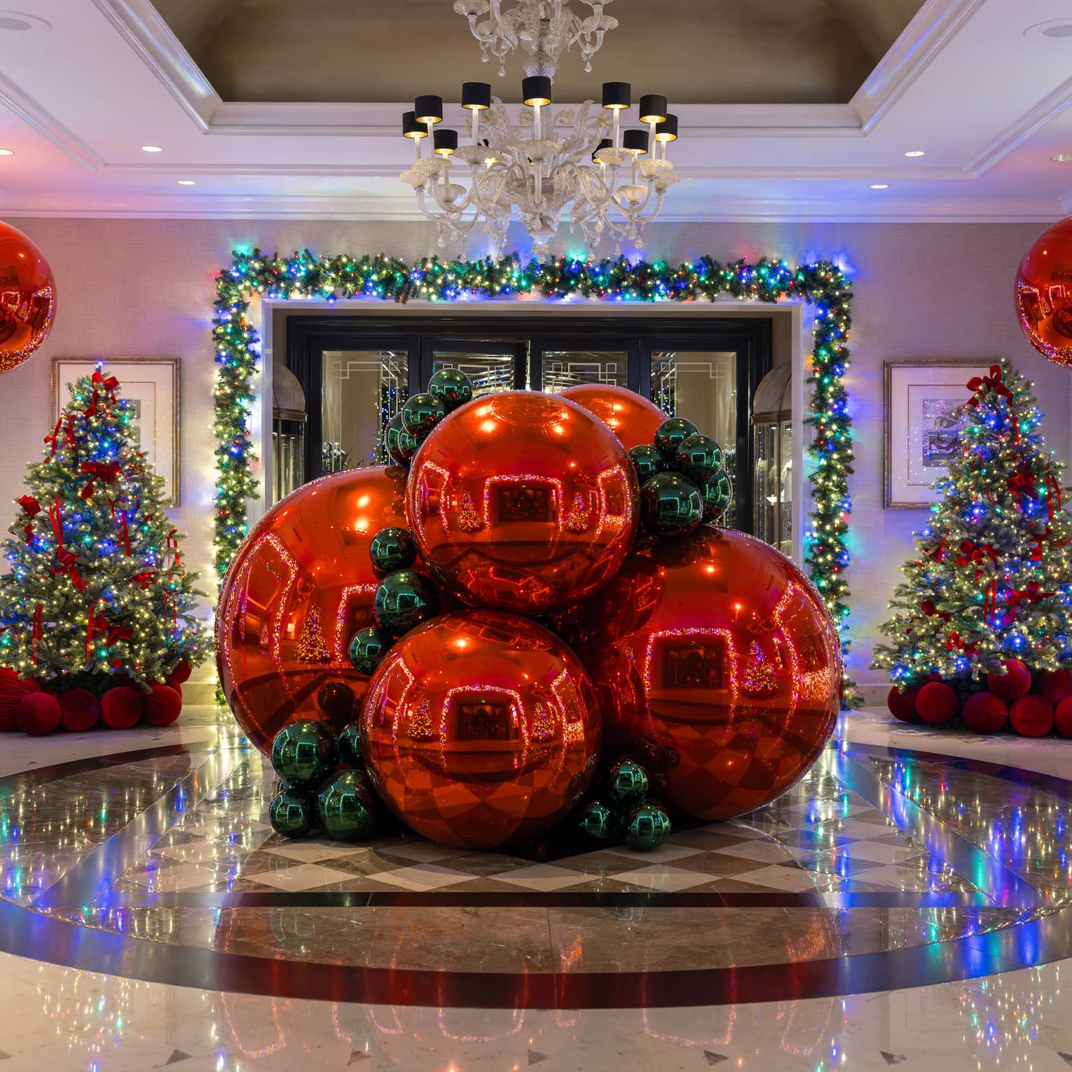 Giant red ornaments set up in a hotel lobby