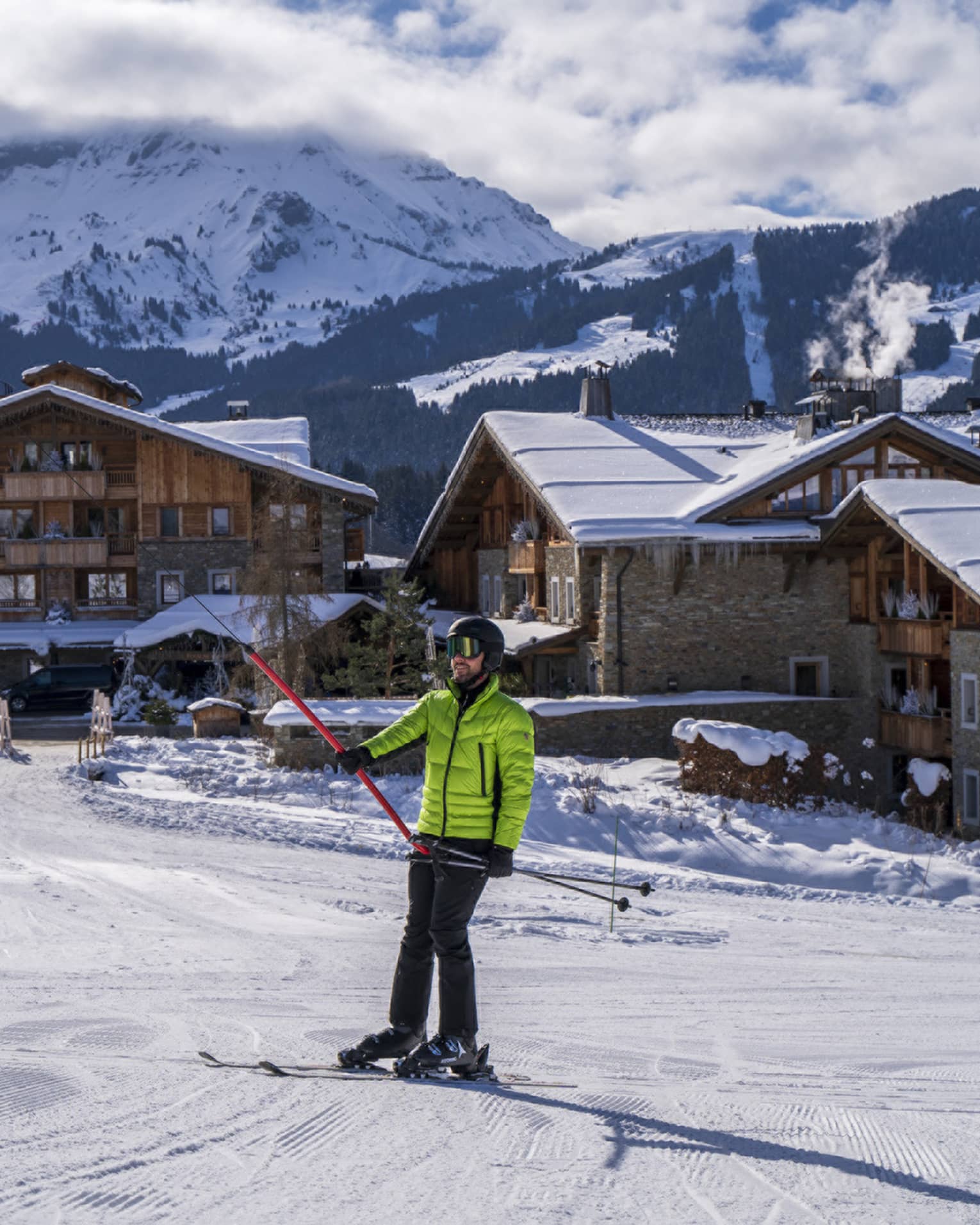 A person in a bright green ski jacket on snow.
