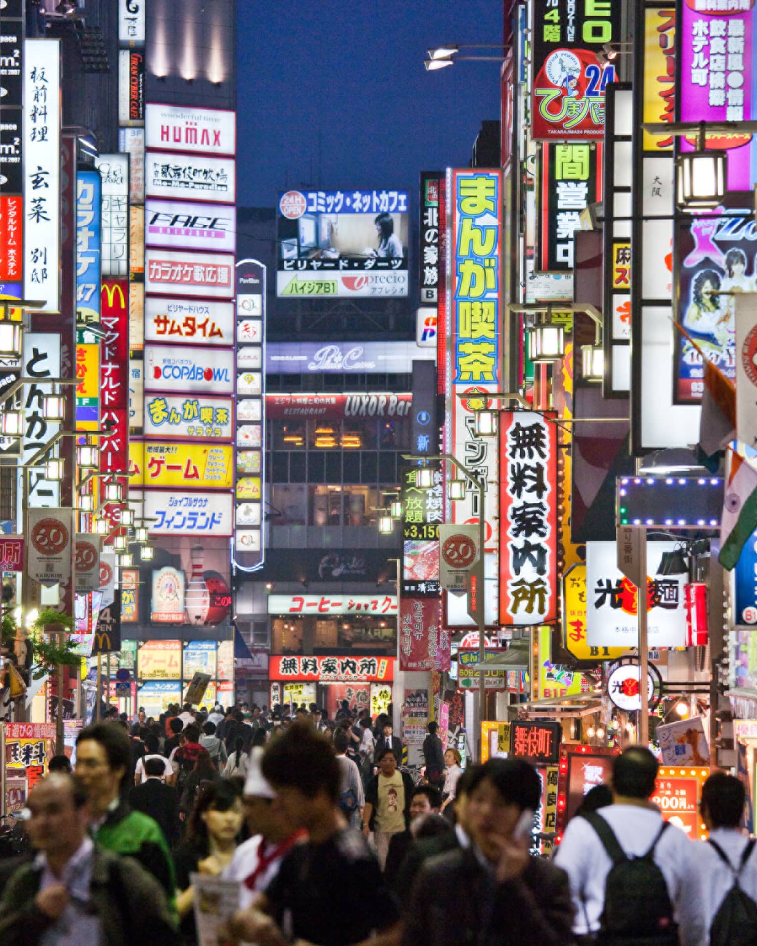 Crowds under Tokyo lights, colourful billboards