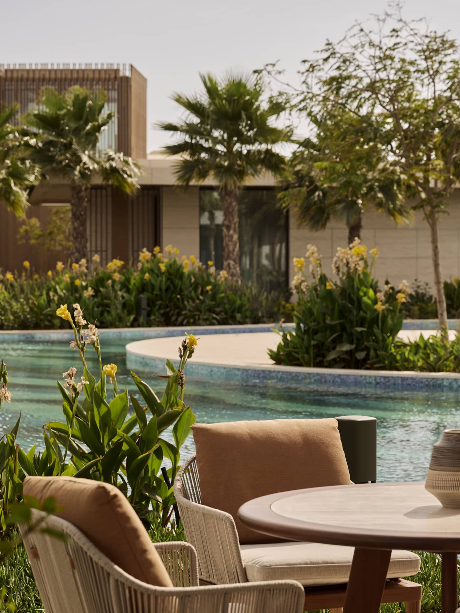 View of a lagoon-style pool from a private terrace at luxury resort