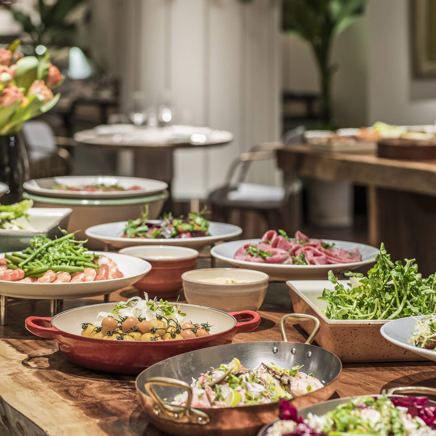 A lunch buffet arranged with platters of seafood, fresh vegetables and a large variety of other options at the One Ninety Restaurant