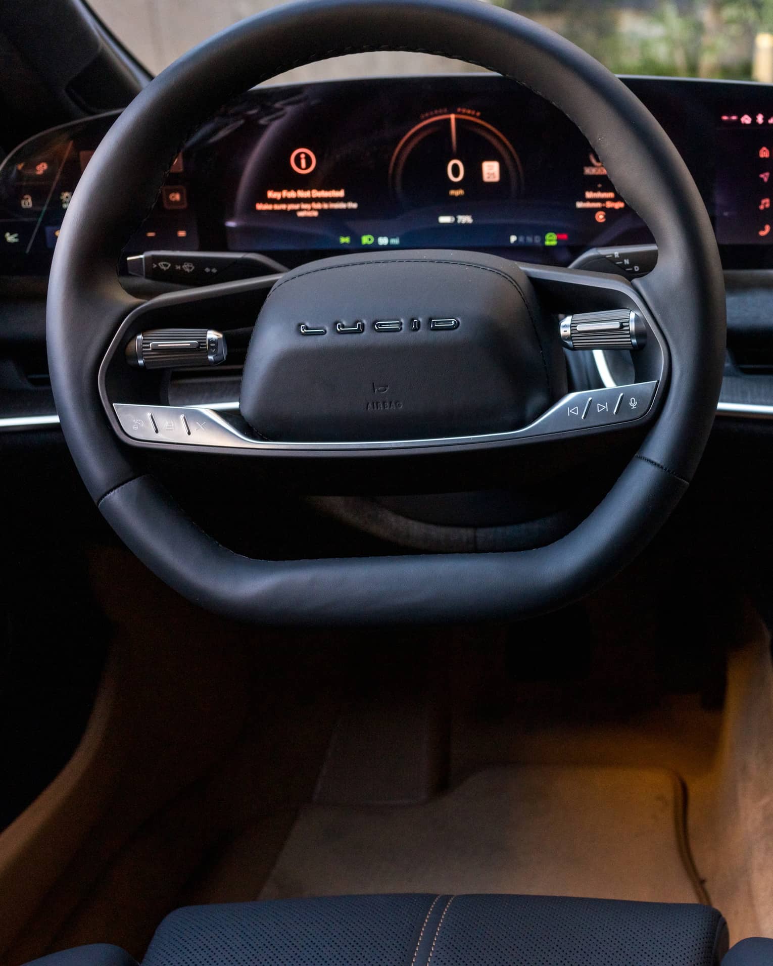 A car dashboard, window and steering wheel