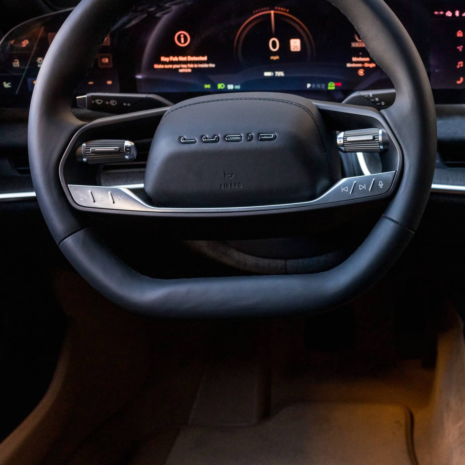 A car dashboard, window and steering wheel