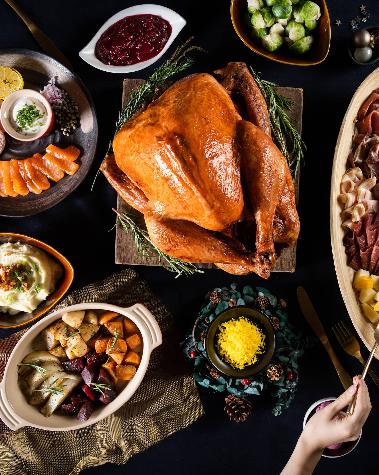Aerial view of table with roasted turkey and various side dishes