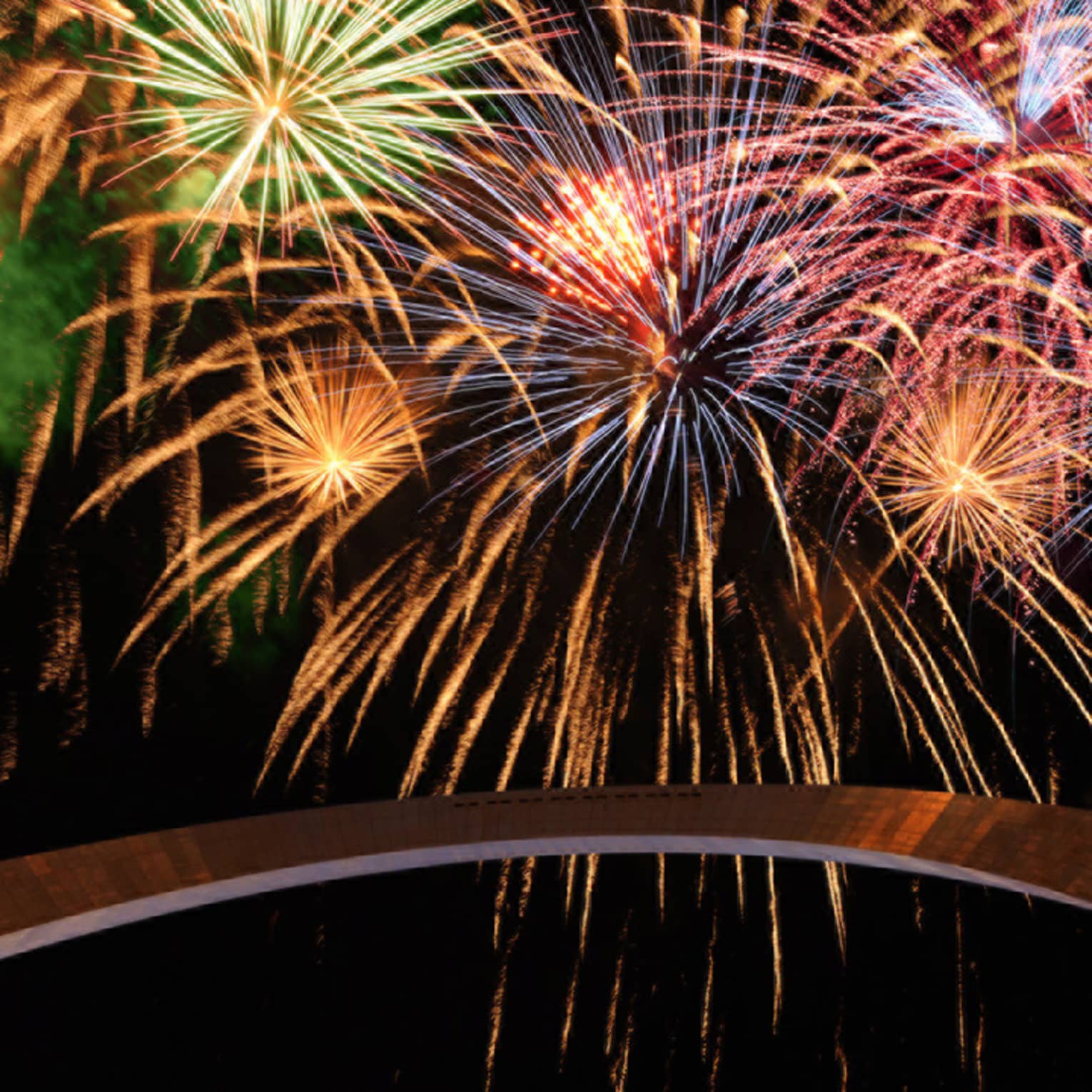 Colourful fireworks light up a night sky over Gateway Arch
