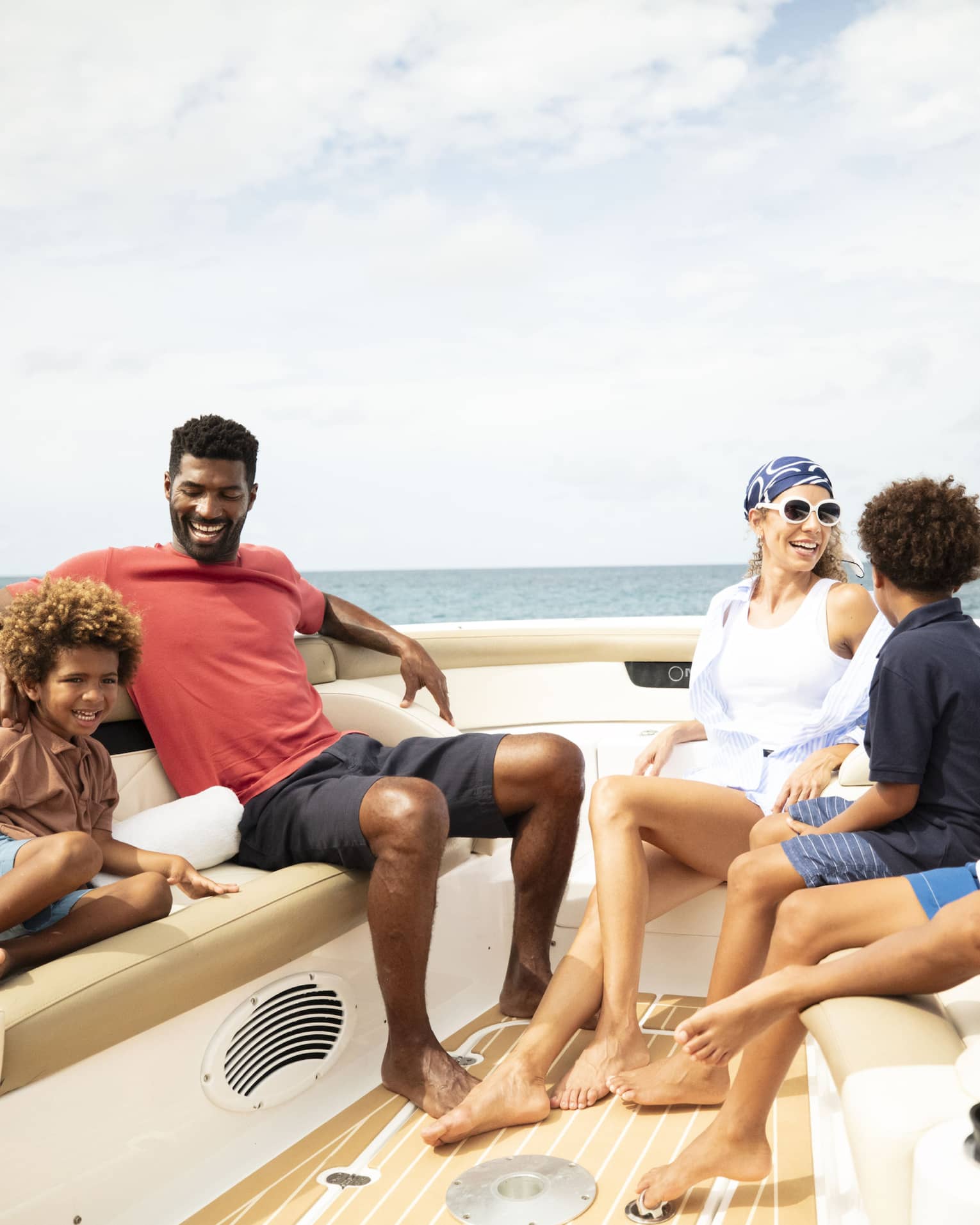 A family sits on a luxury boat on the ocean