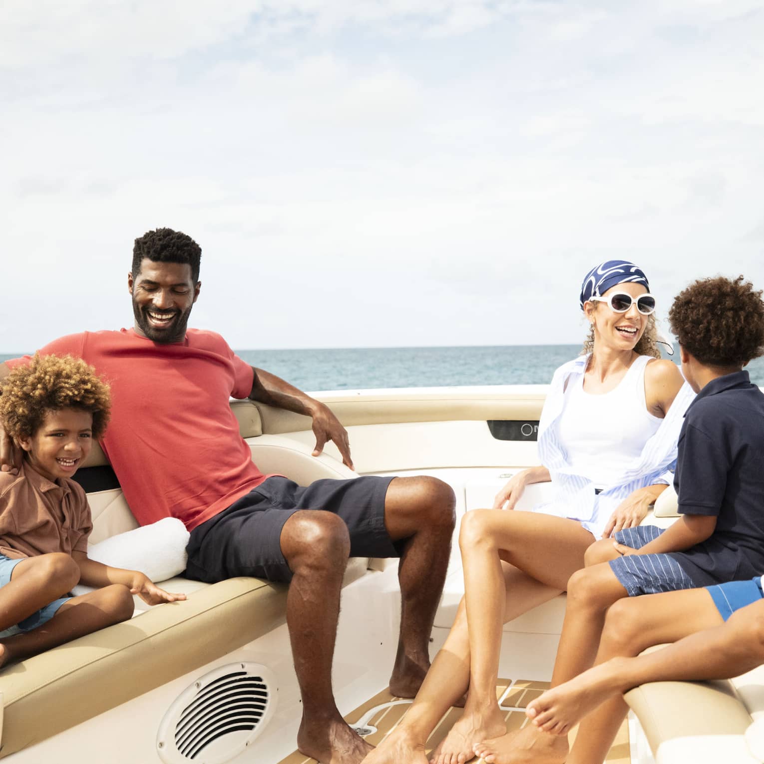 A family sits on a luxury boat on the ocean