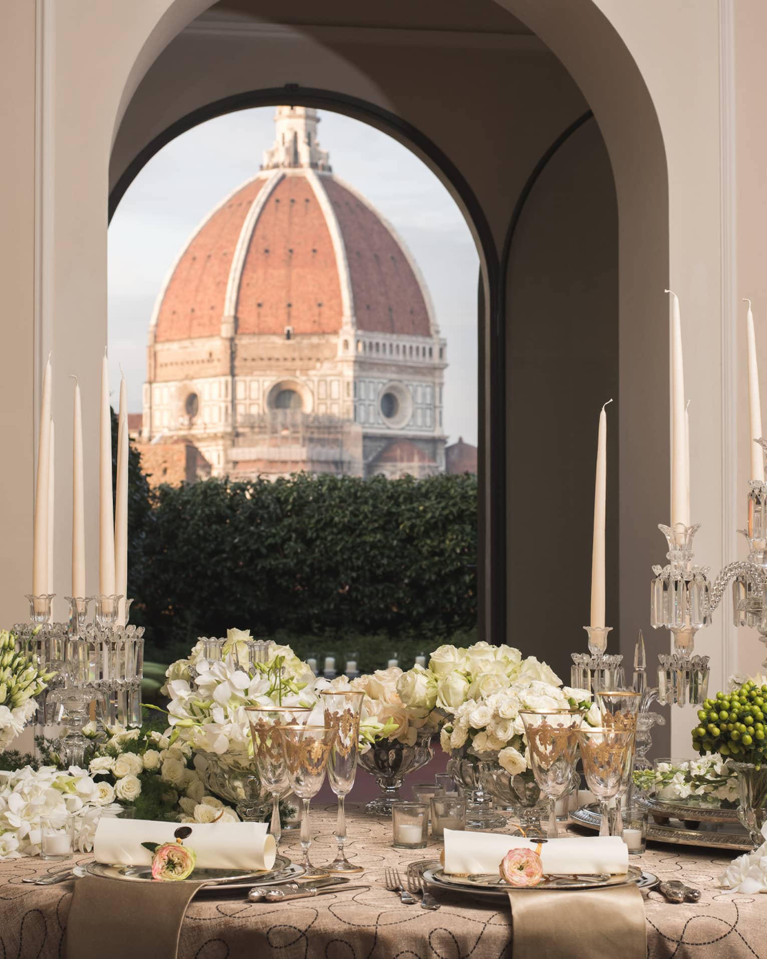 White roses, flowers on elegant banquet table under pillows, Duomo views