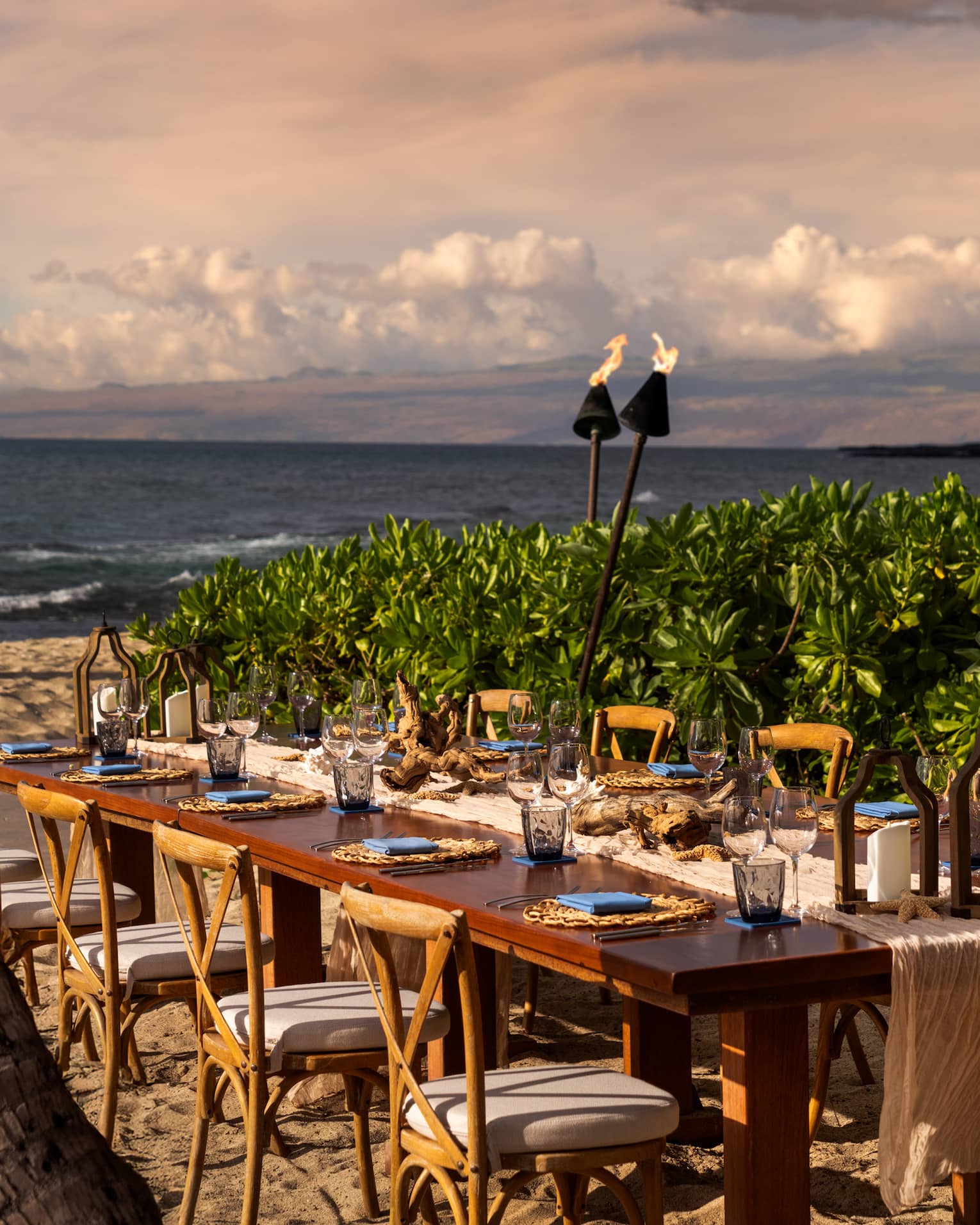 Private dining table seating 10 on the beach in tropical settig