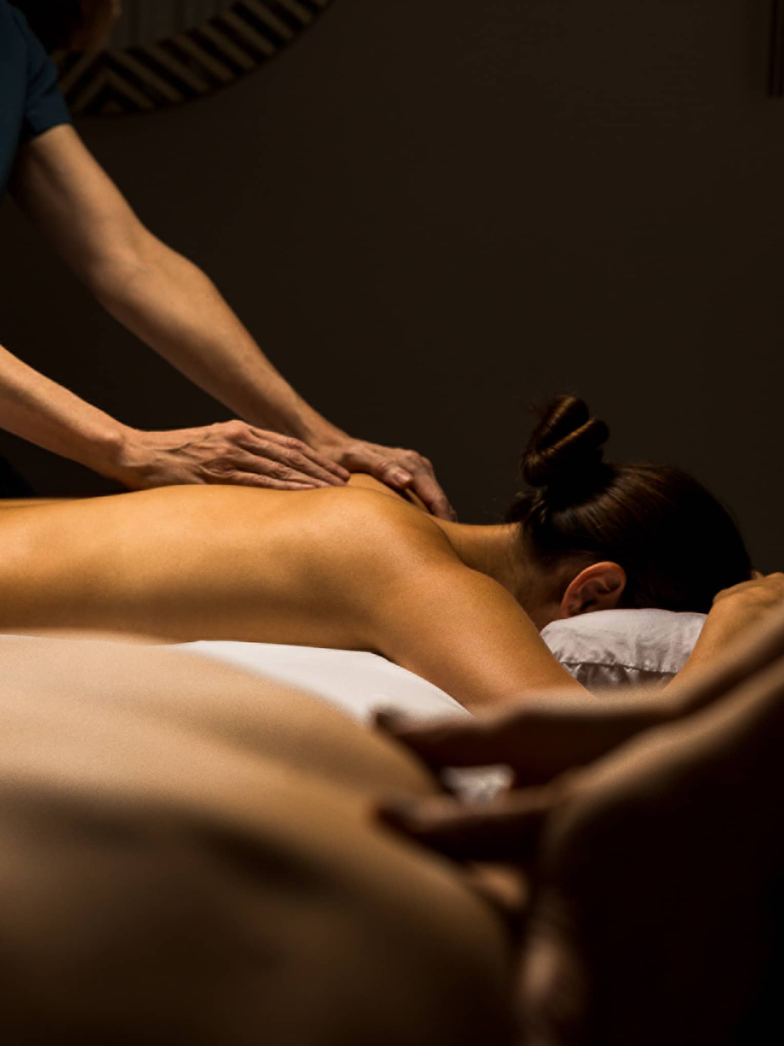 Two guests lay side by side for massage treatments