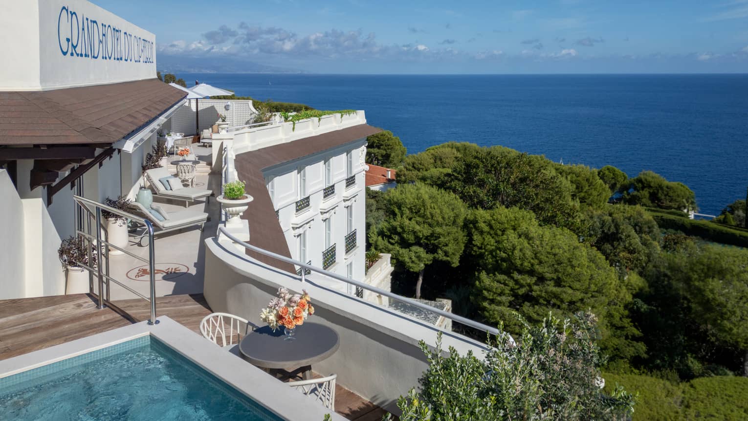View from a penthouse suite with plunge pool, overlooking gardens and sea