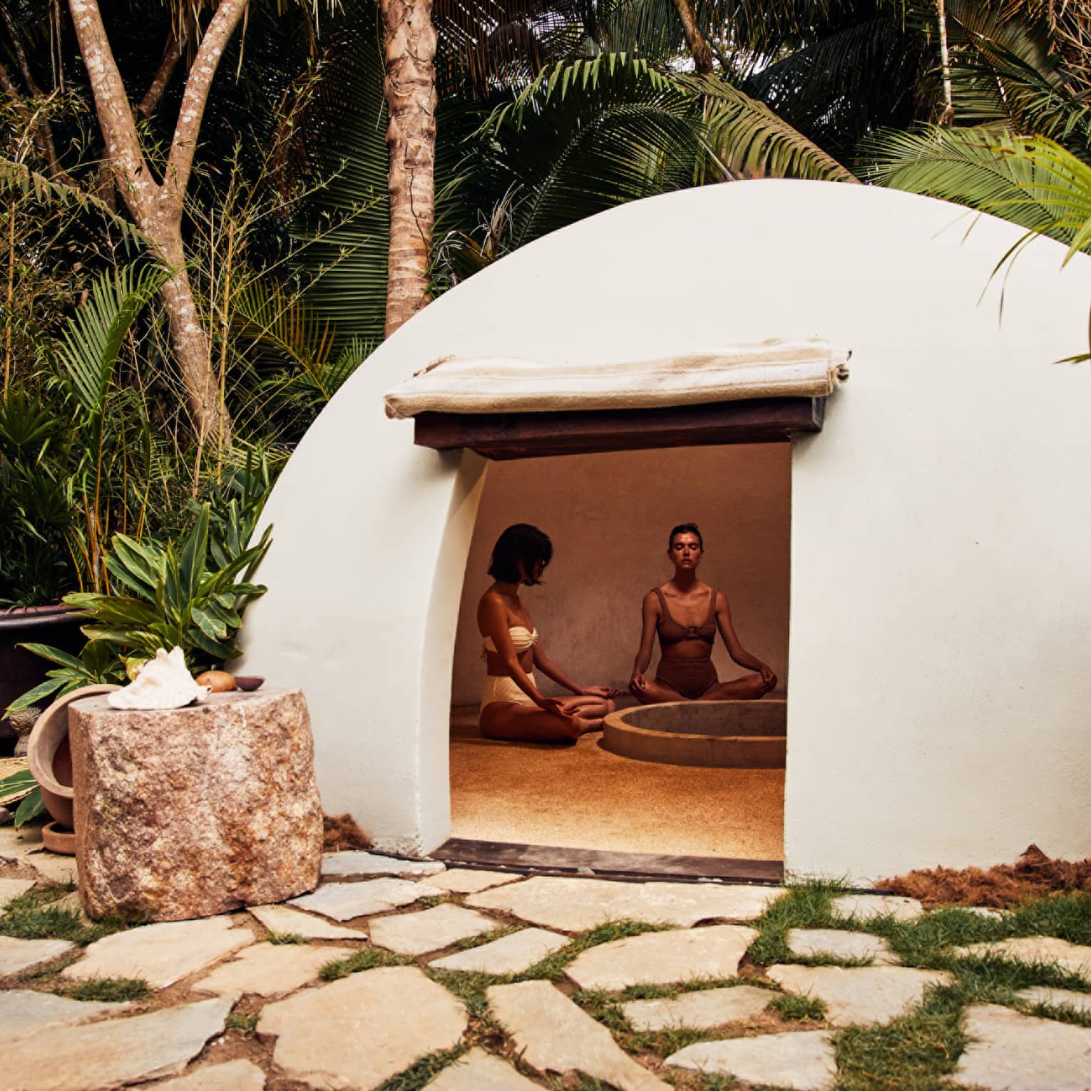 A heated dome shaped room surrounded by trees.
