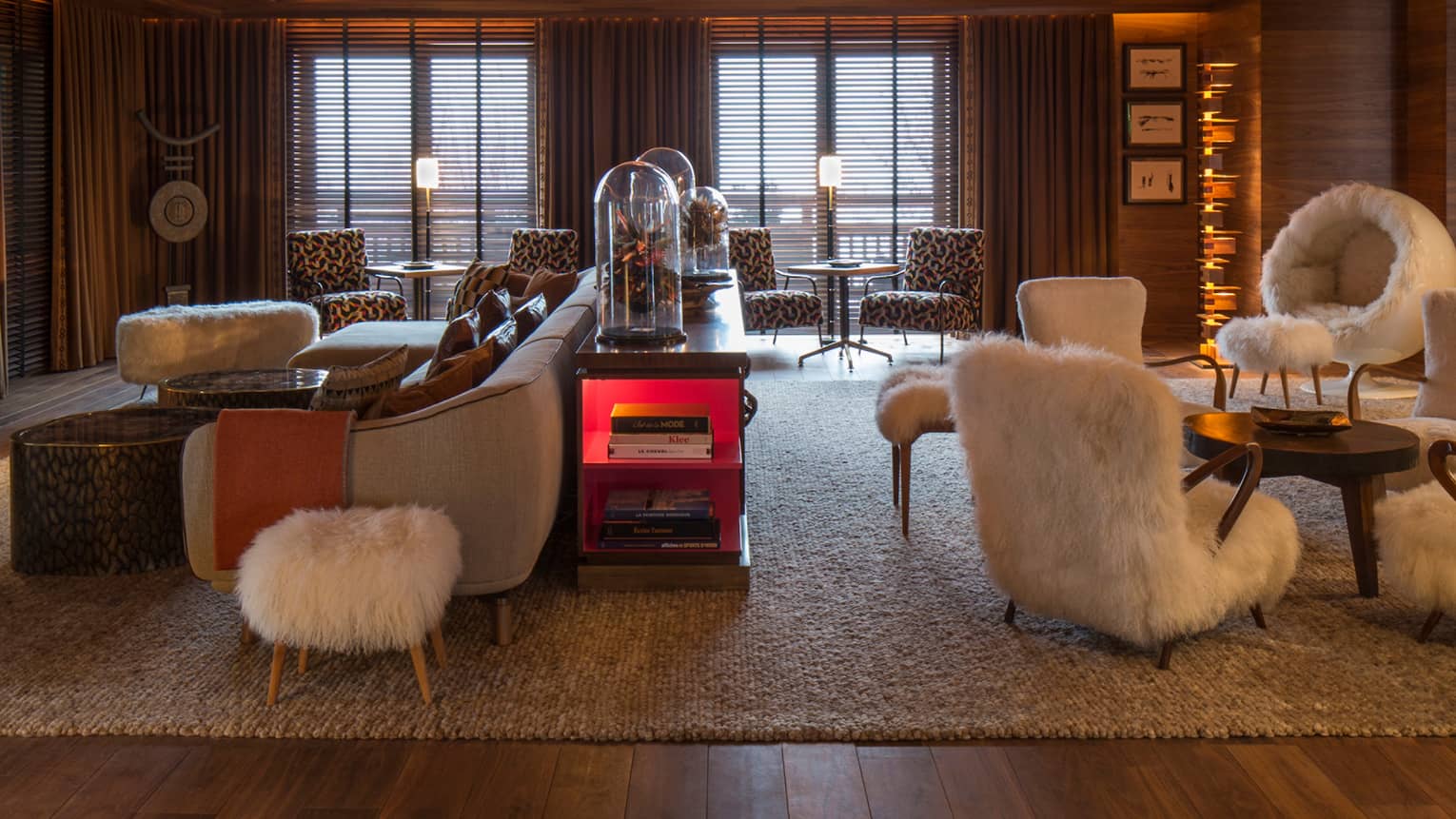 Lobby Lounge wood angular ceiling with lights over retro-style furniture, white faux fur chairs