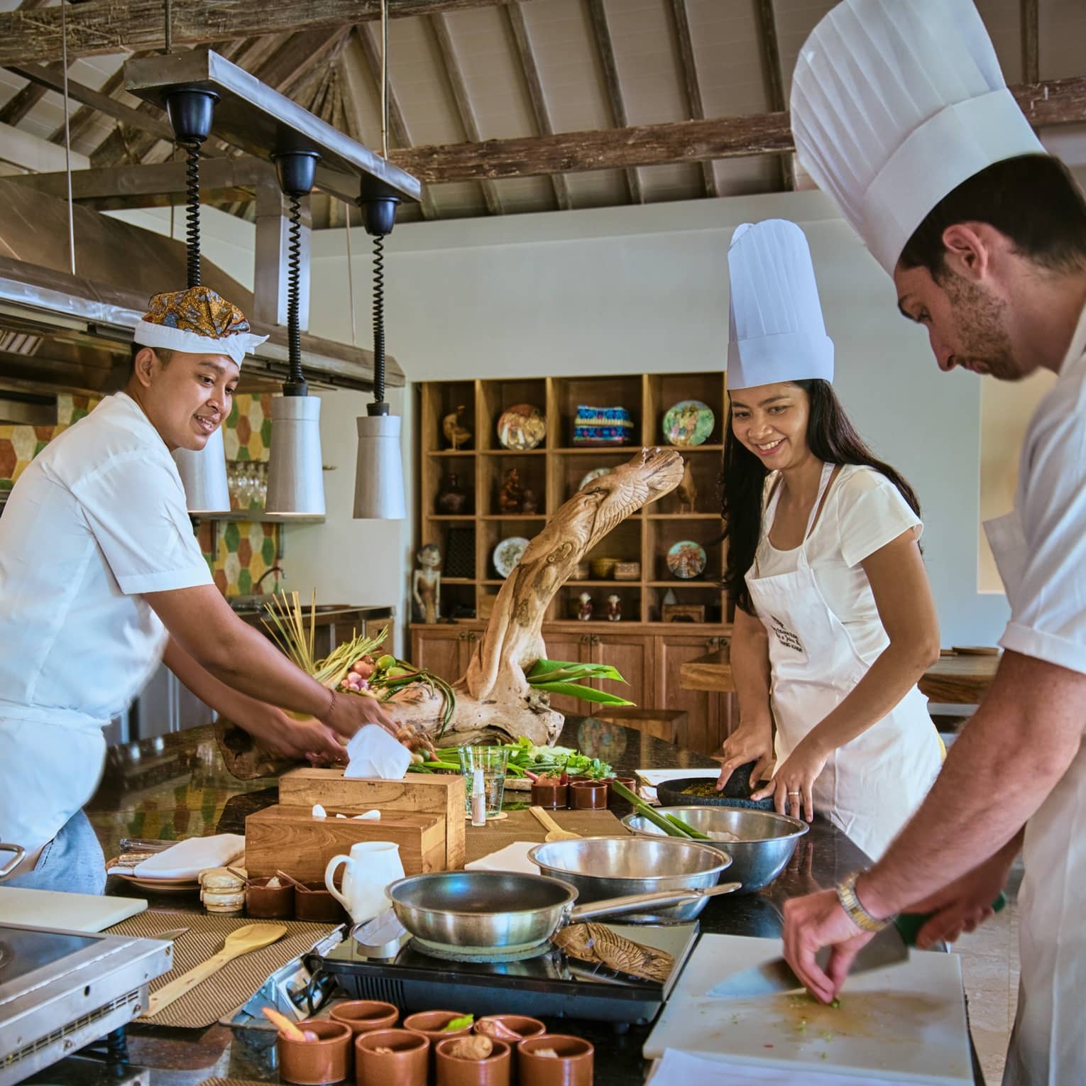 Two guests receive cooking lesson at Four Seasons hotel