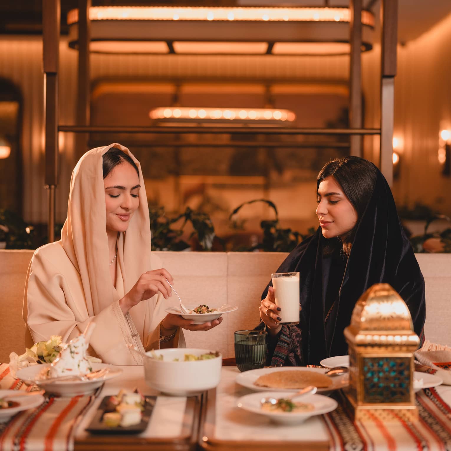 Two people sit at a restaurant booth