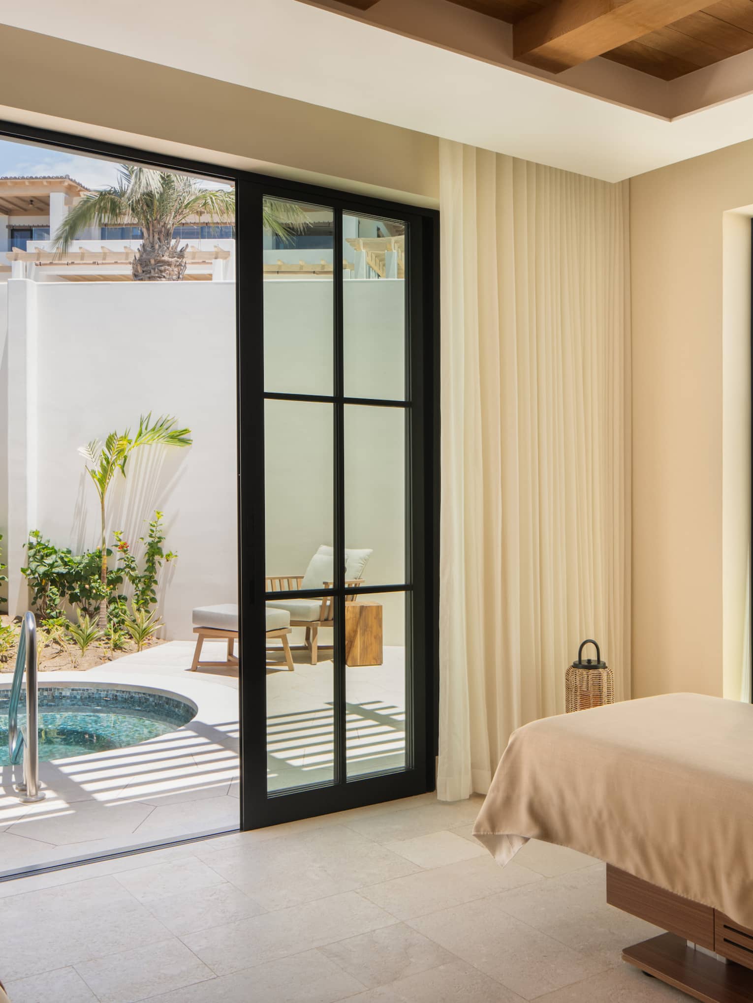 Luxury spa treatment room with access to private outdoor tub at Four Seasons Resort Cabo San Lucas at Cabo Del Sol