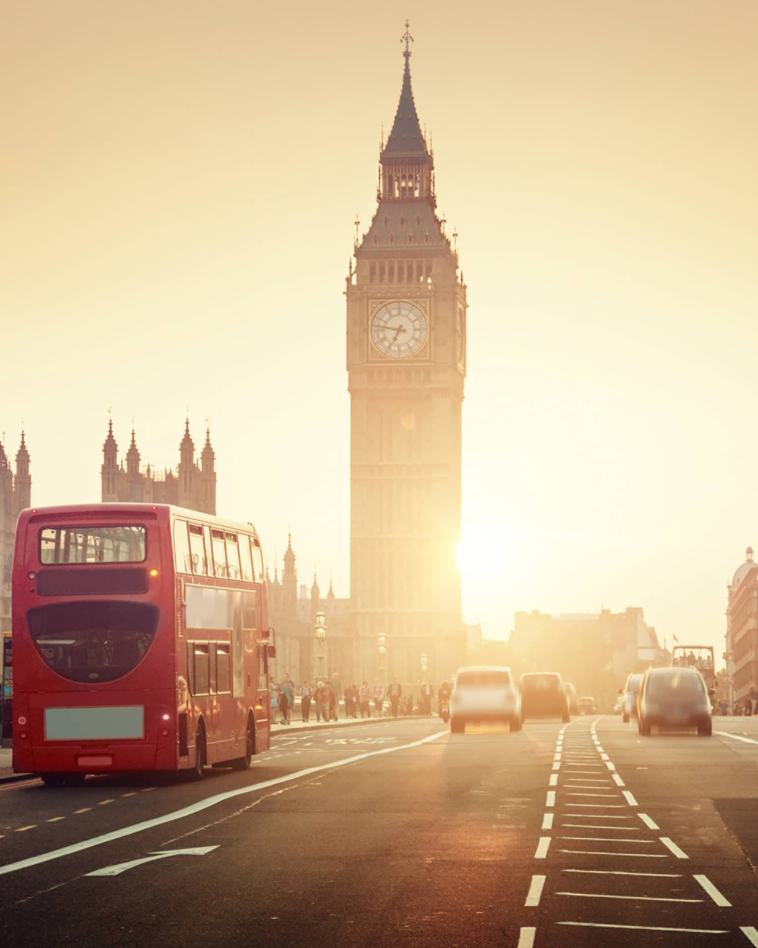 Street view of London at sunset, Big Ben tower and red double-decker bus in background