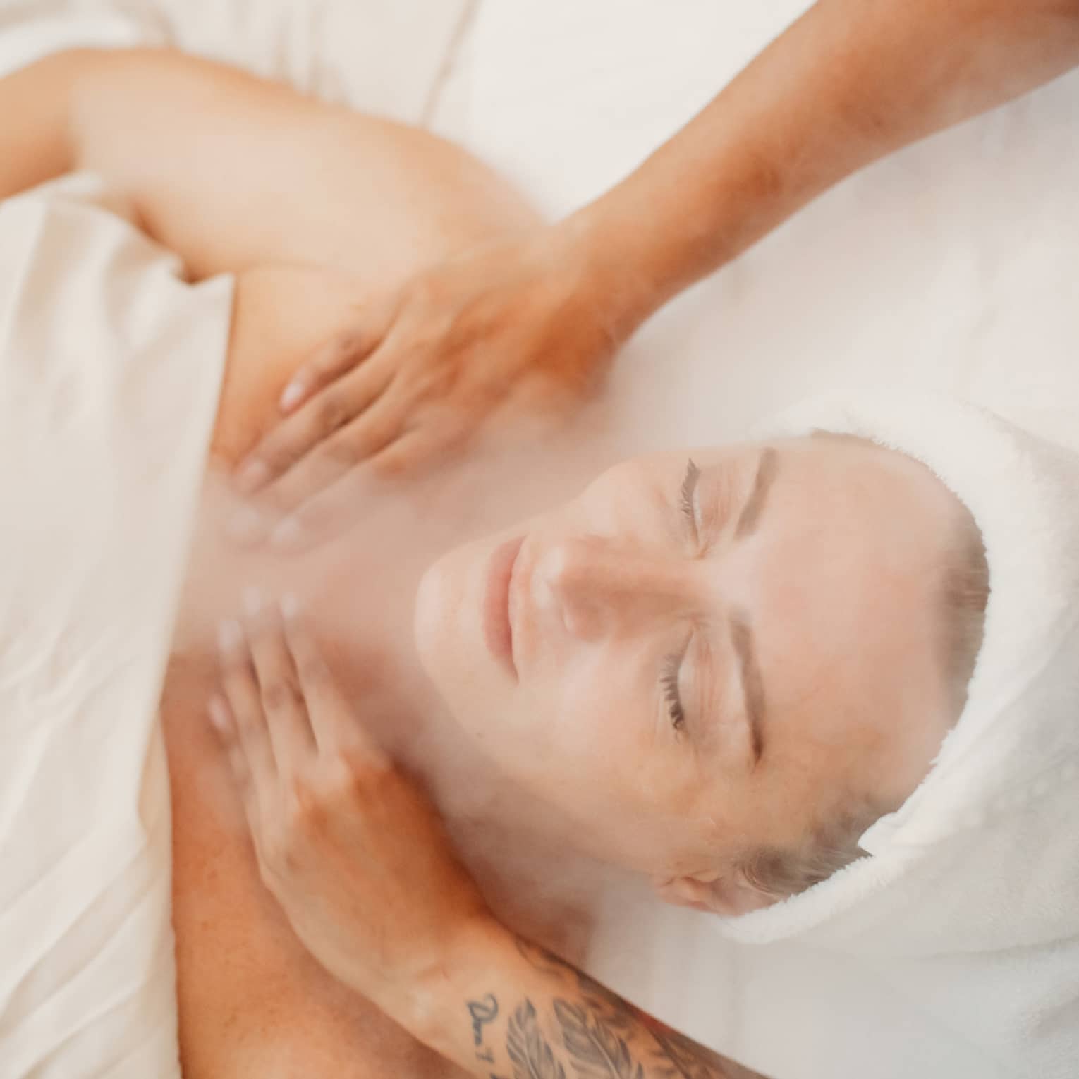 A woman receiving a facial massage in a spa.