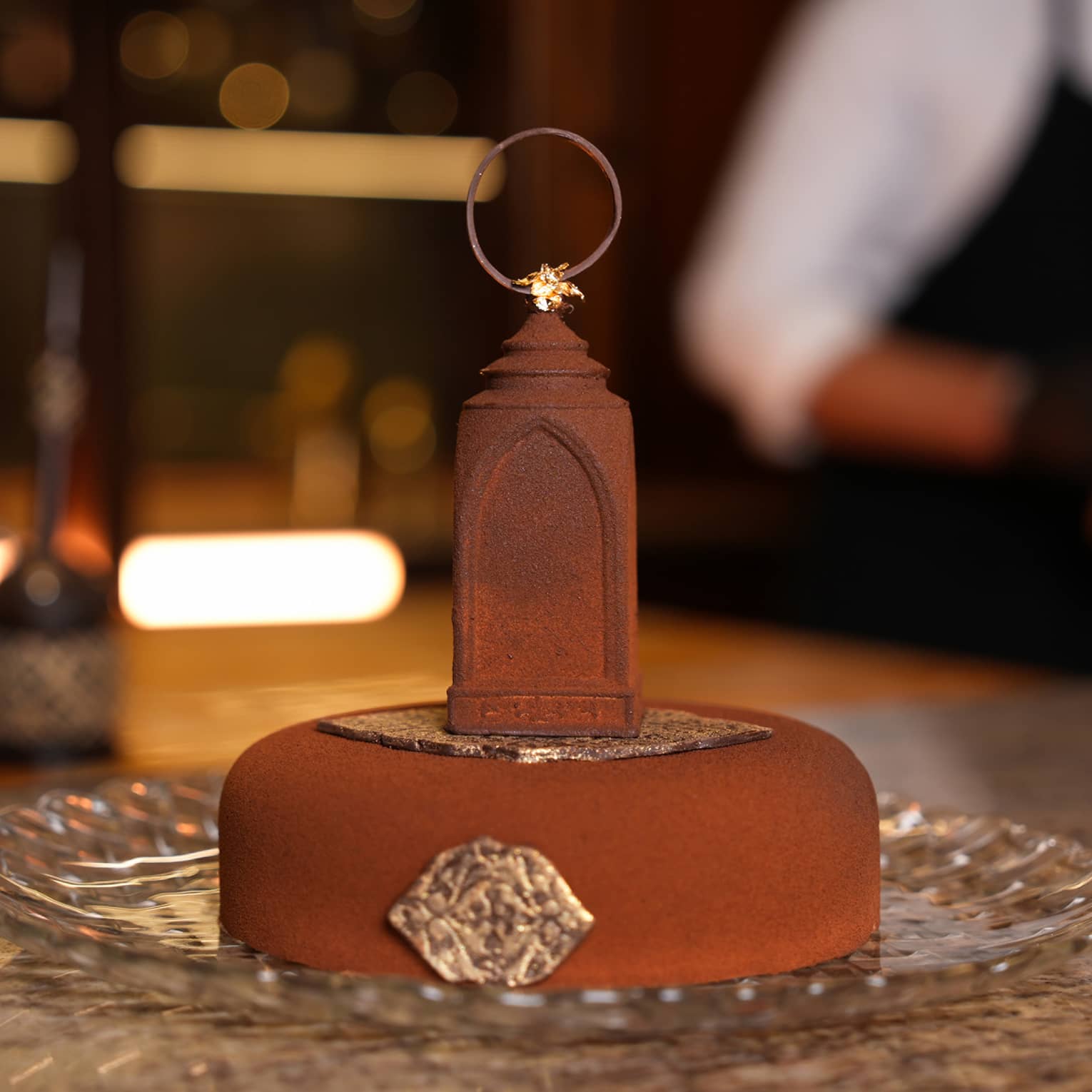 Ramadan-themed cake served on a glass platter