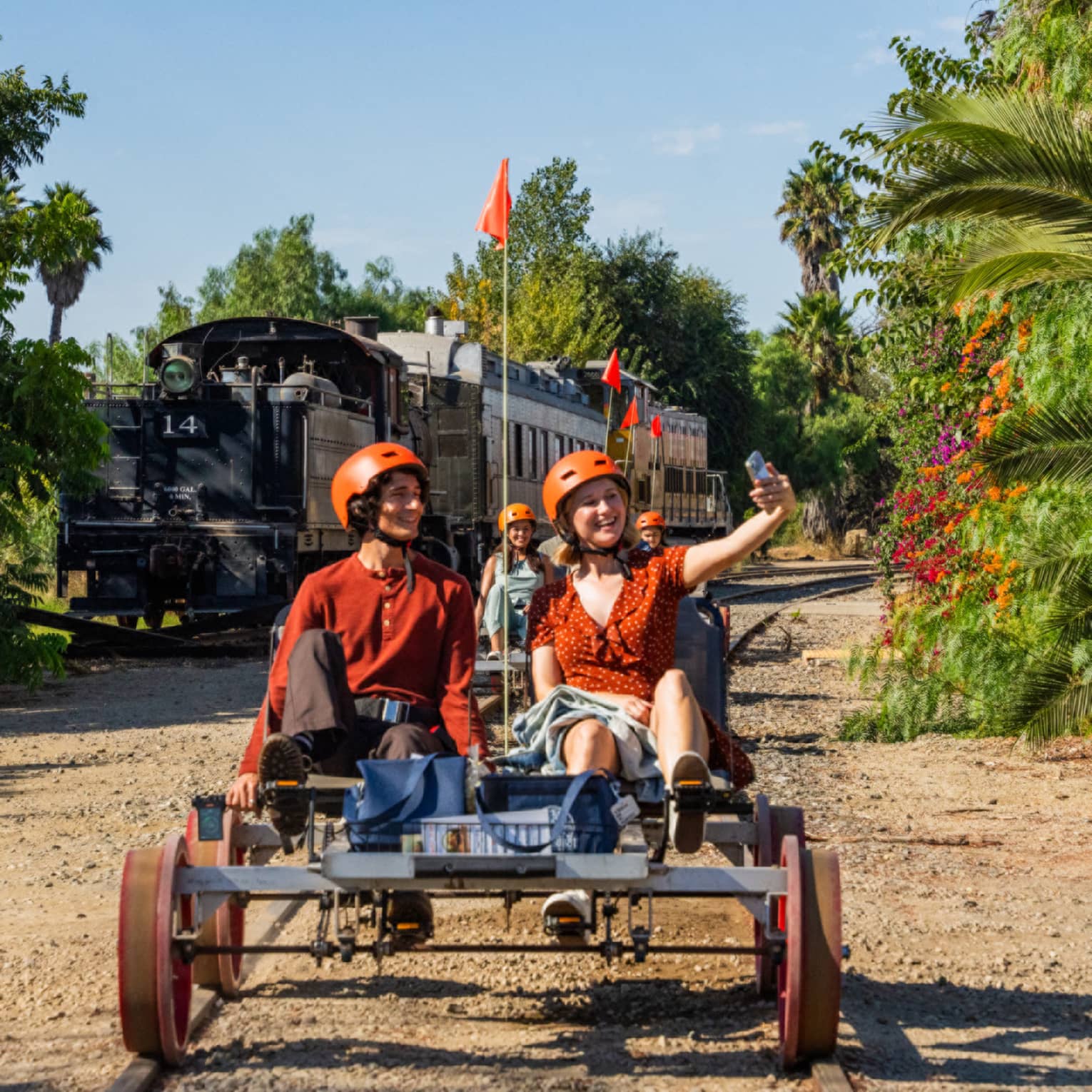 Two guests riding a railbike on a track outside