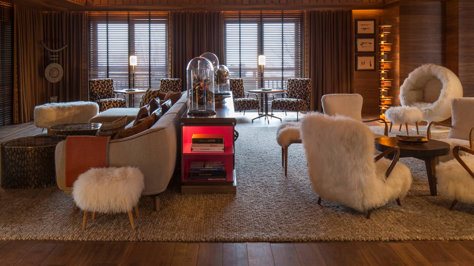 Lobby Lounge wood angular ceiling with lights over retro-style furniture, white faux fur chairs