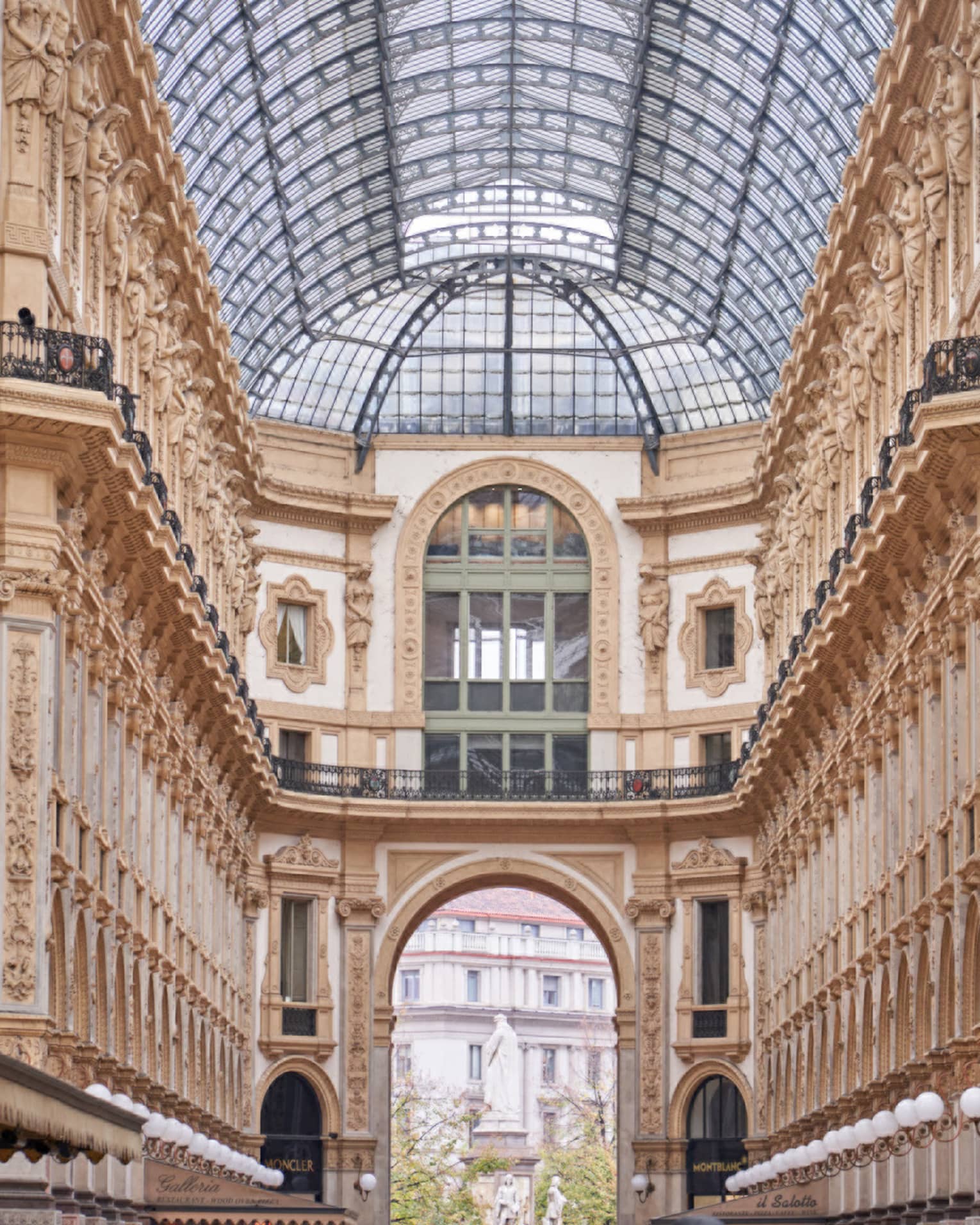 Historic Milan buildings and shops under glass vaulted ceiling