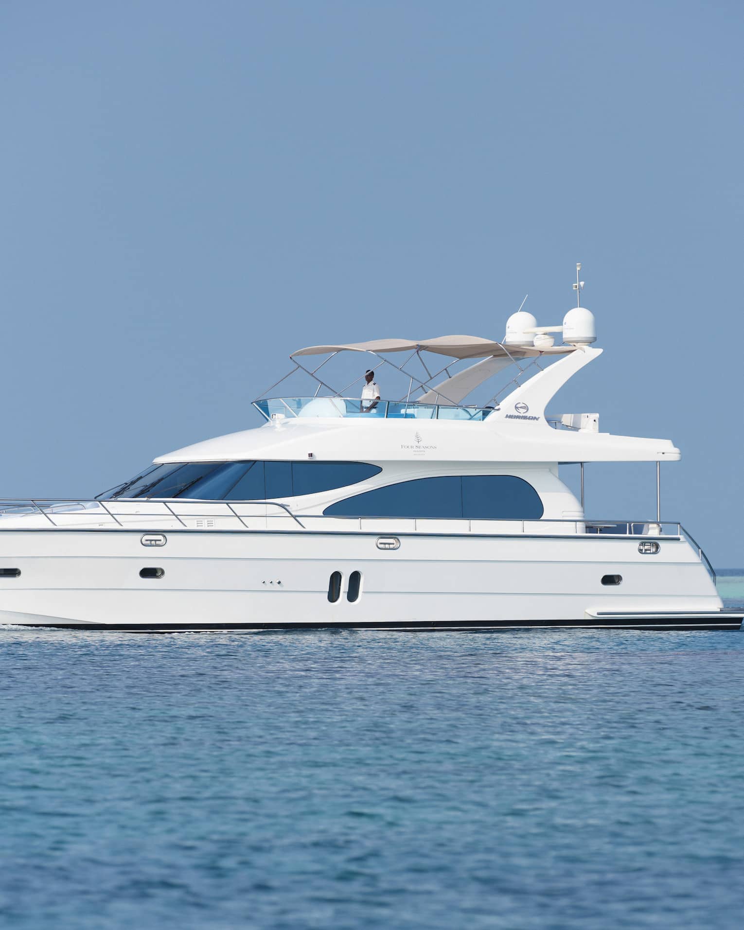 Small white private luxury yacht sailing on ocean