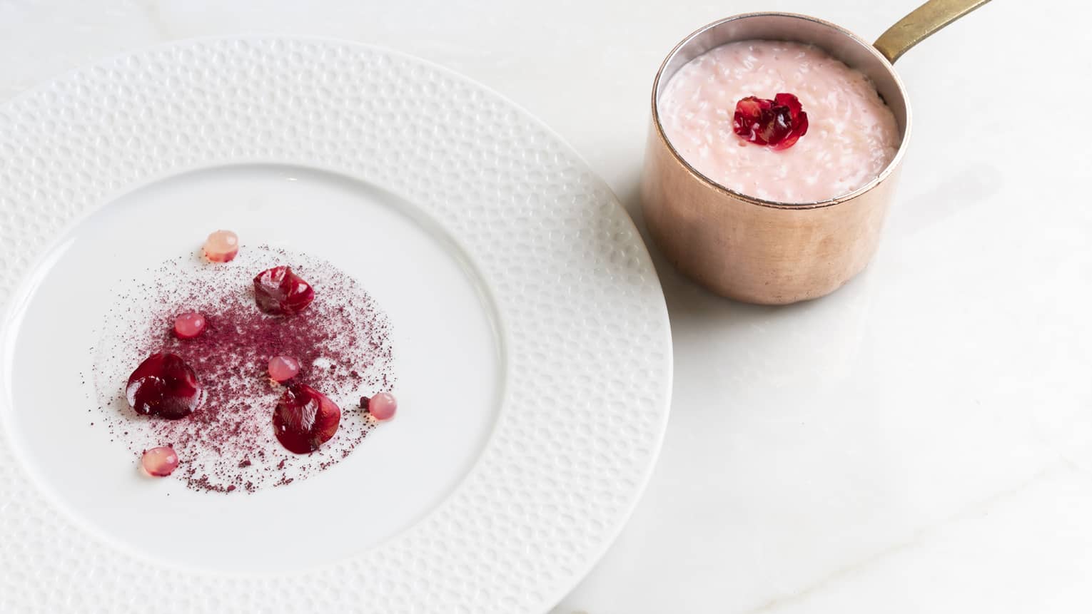 Pink risotto on a white plate.