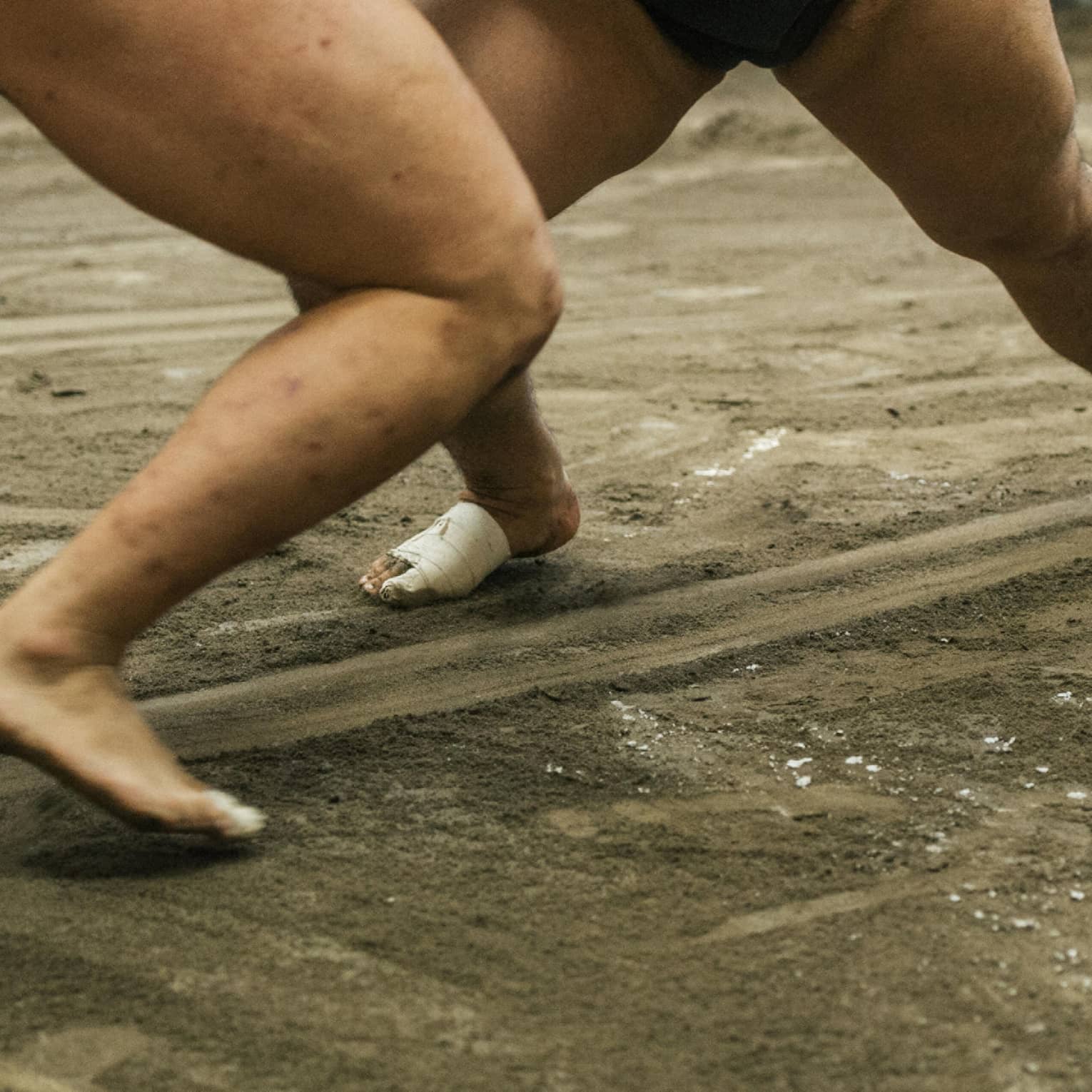 Two sumo wrestlers participate in a match