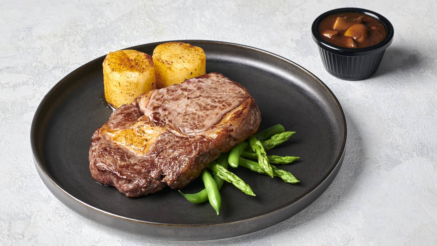 Ribeye with Seasonal Greens, Crispy Potato Fondant and Mushroom Sauce