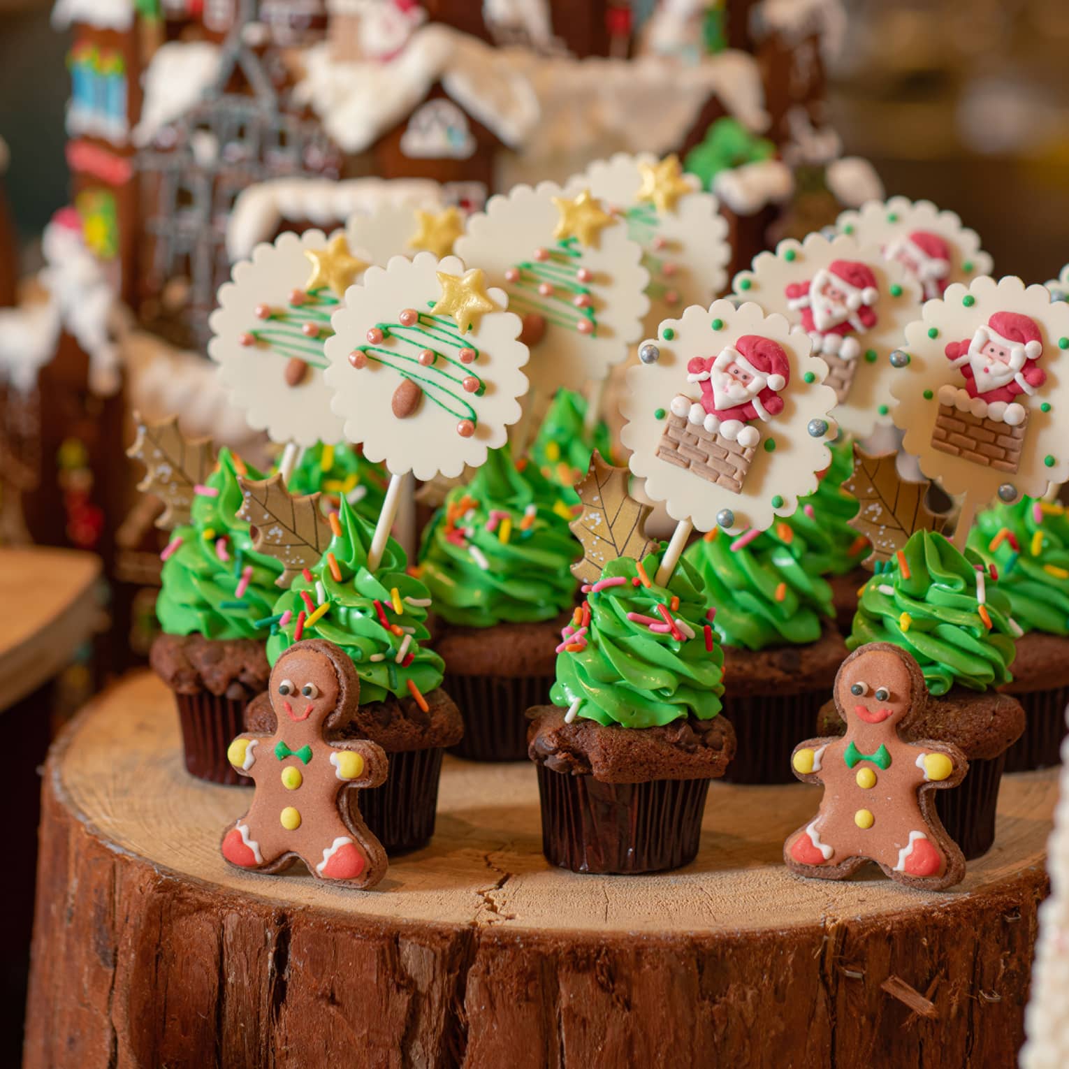 Various Christmas confections lined up on a log