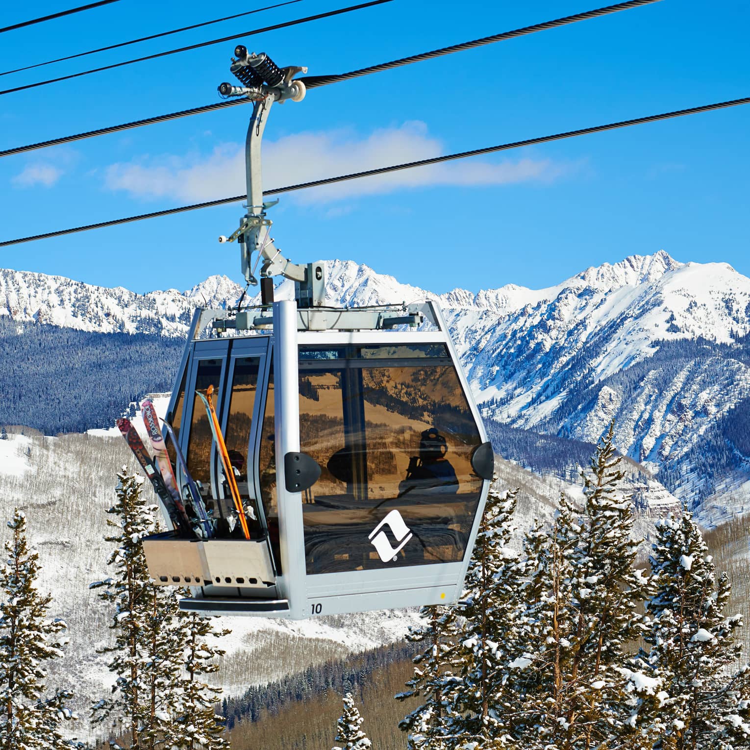 Ski lift heads uphill on snowy Vail, Colorado mountain