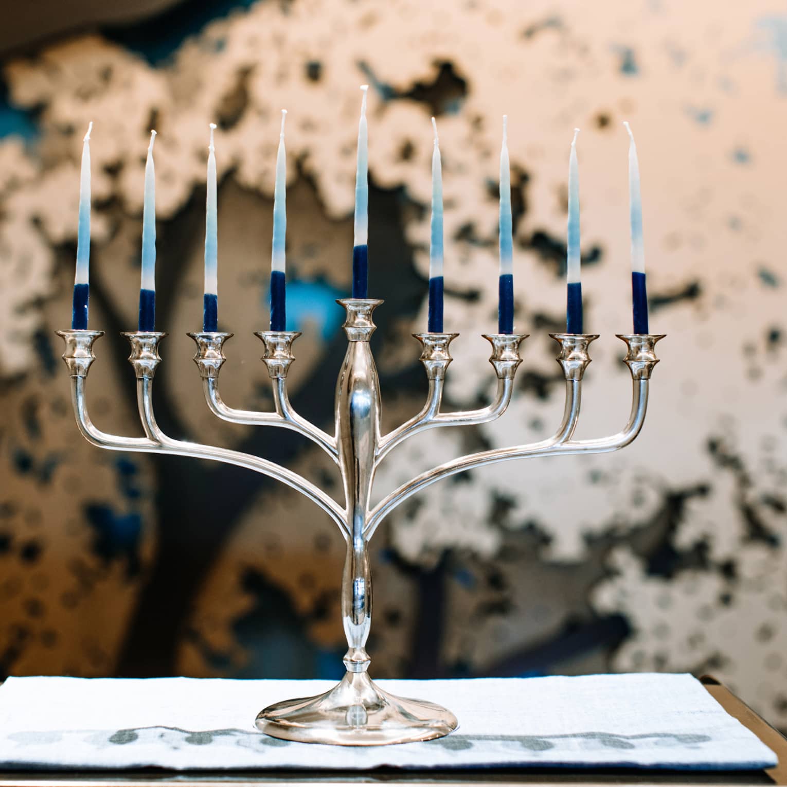 A silver menorah with 9 candles.