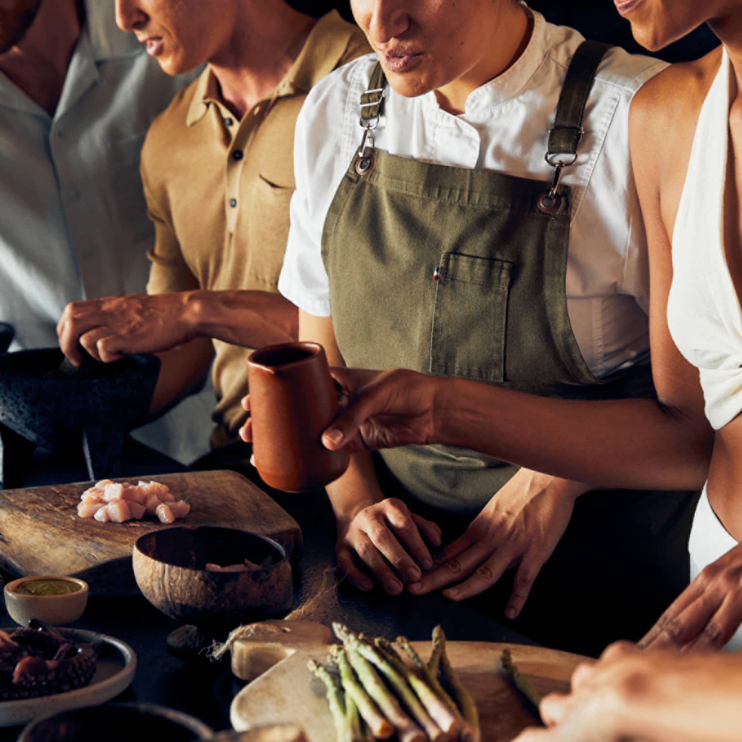 A group of people cooking food.