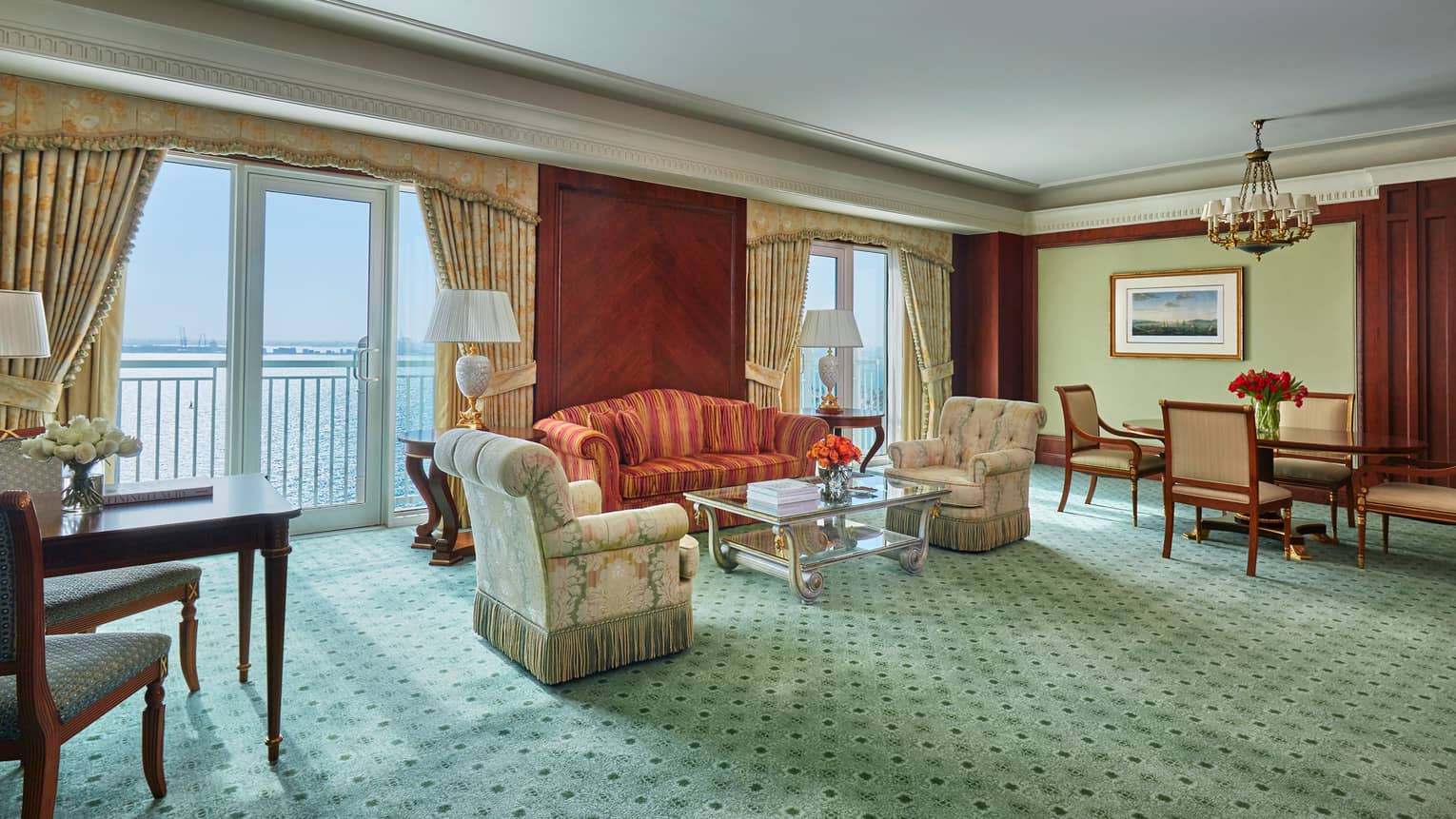 Gulf Suite large living room with pink-and-green armchairs with fringe, striped sofa, green carpet