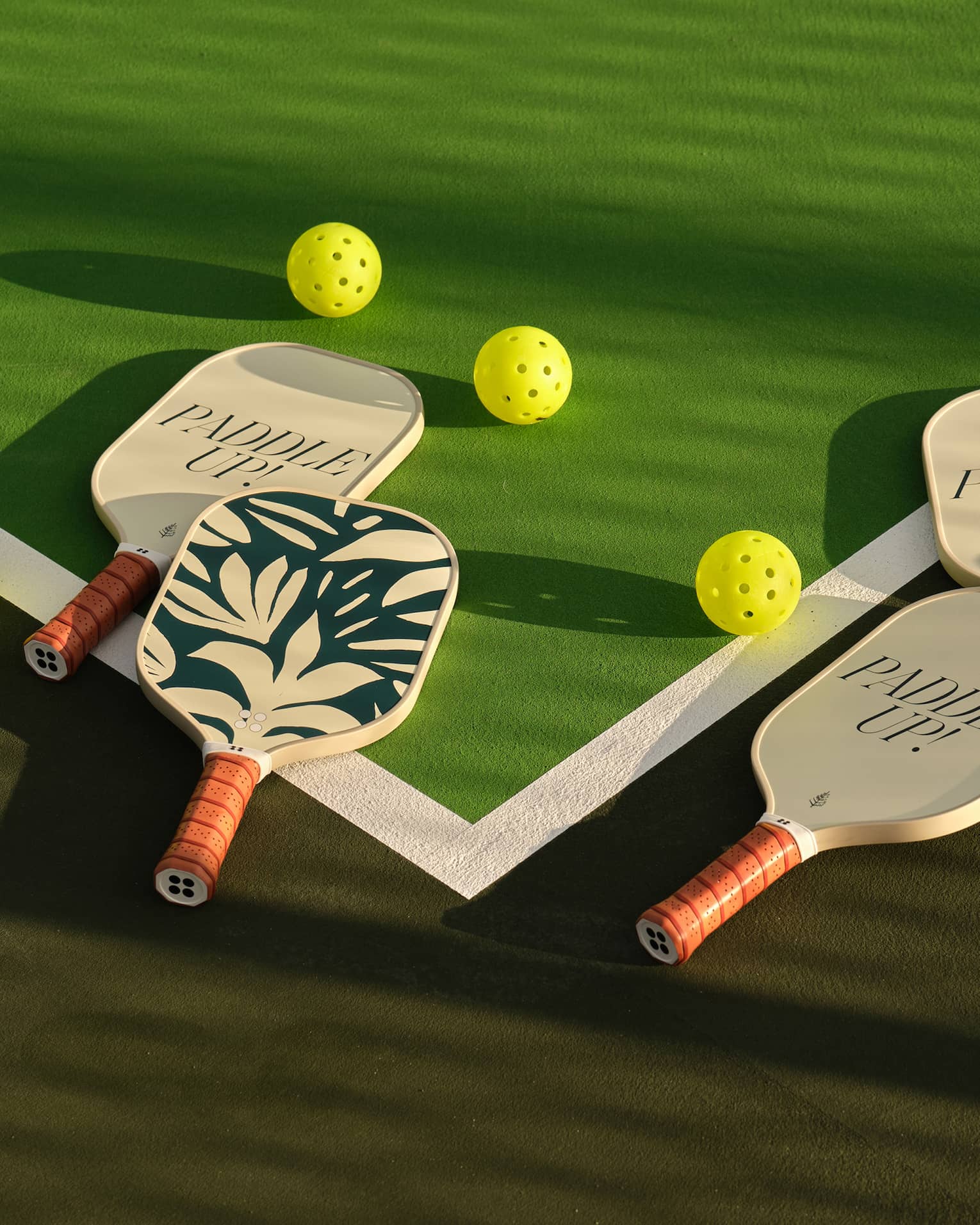 Pickleball paddles on a pickleball court