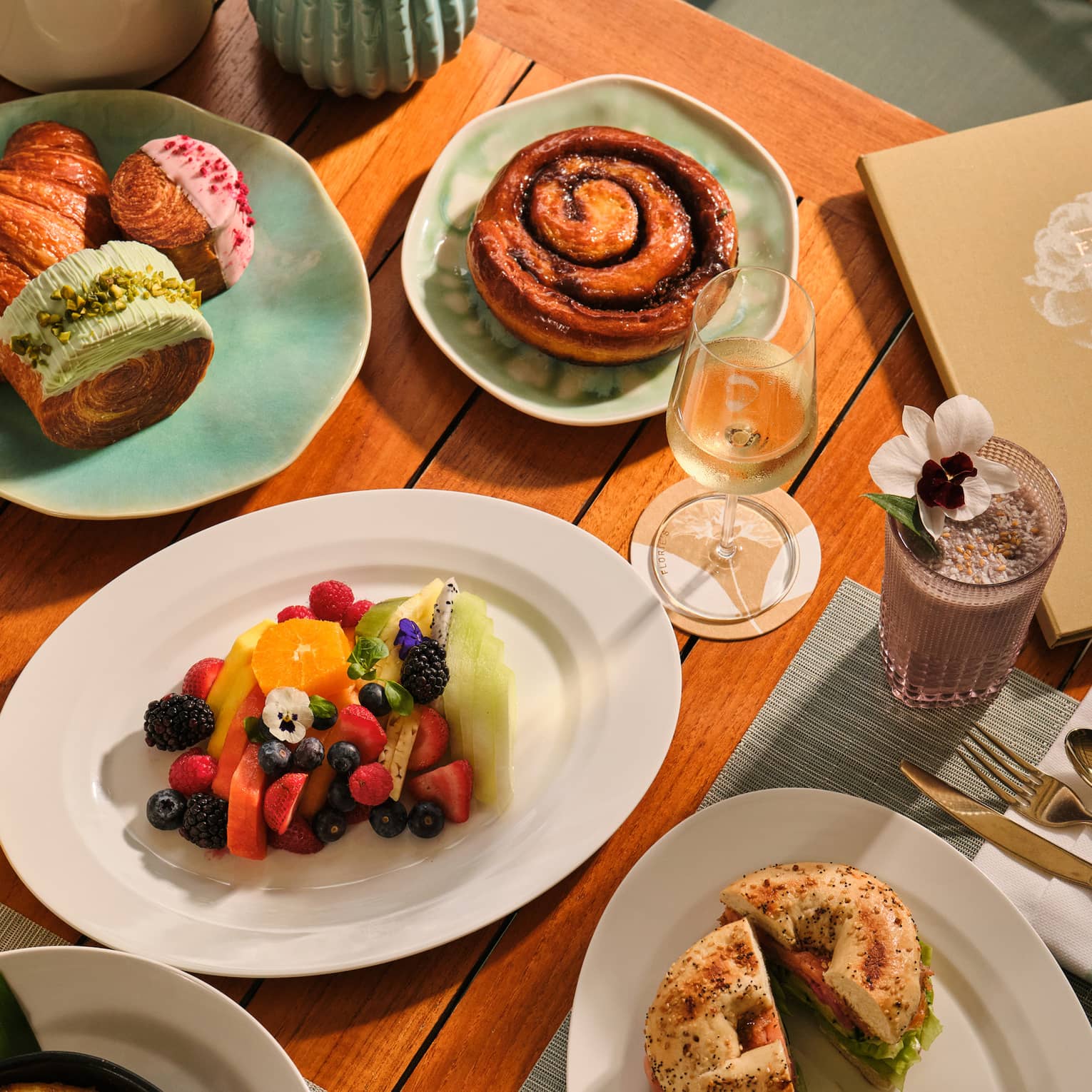 Outdoor table filled with a variety of breakfast dishes