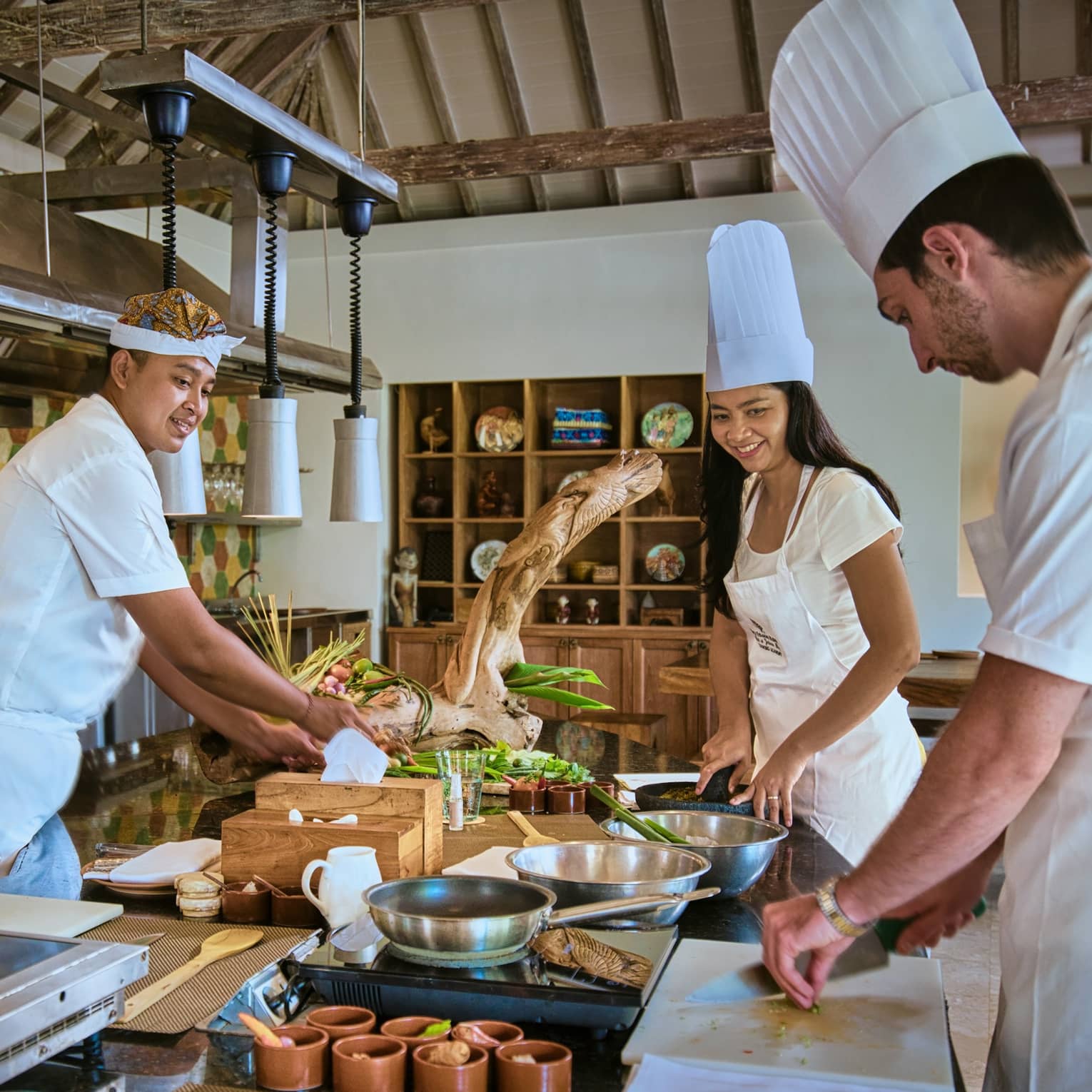 Two guests receive cooking lesson at Four Seasons hotel