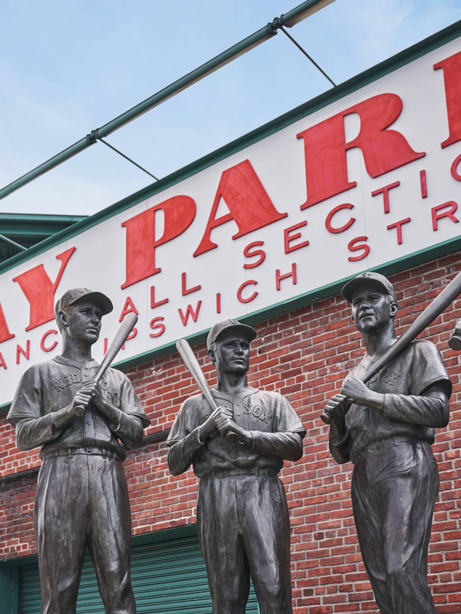 In front of Fenway Park’s Gate 5 is a bronze statue, called The Teammates, of four former Red Sox players in their uniforms.