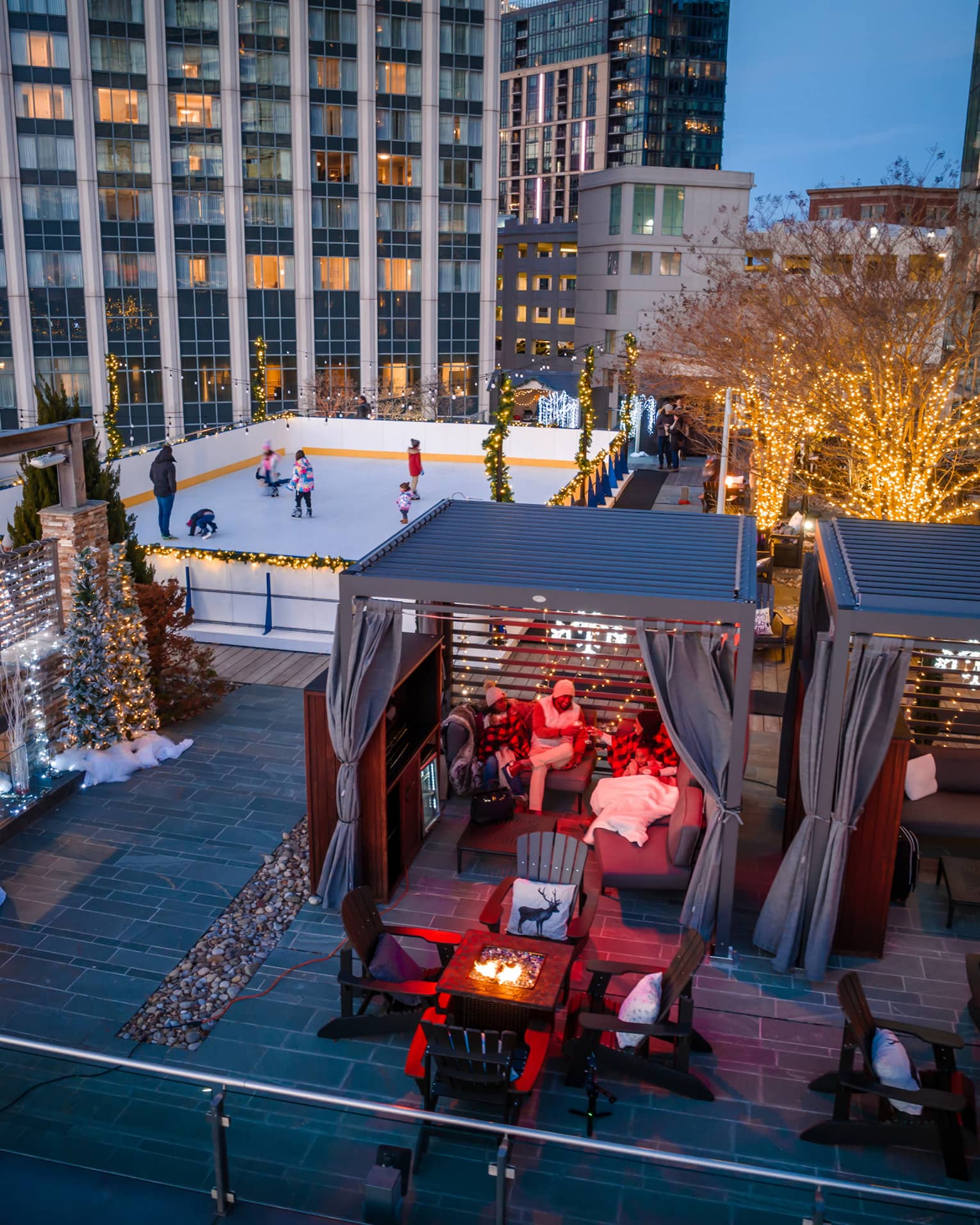 A rooftop with ice skating, and chalets.